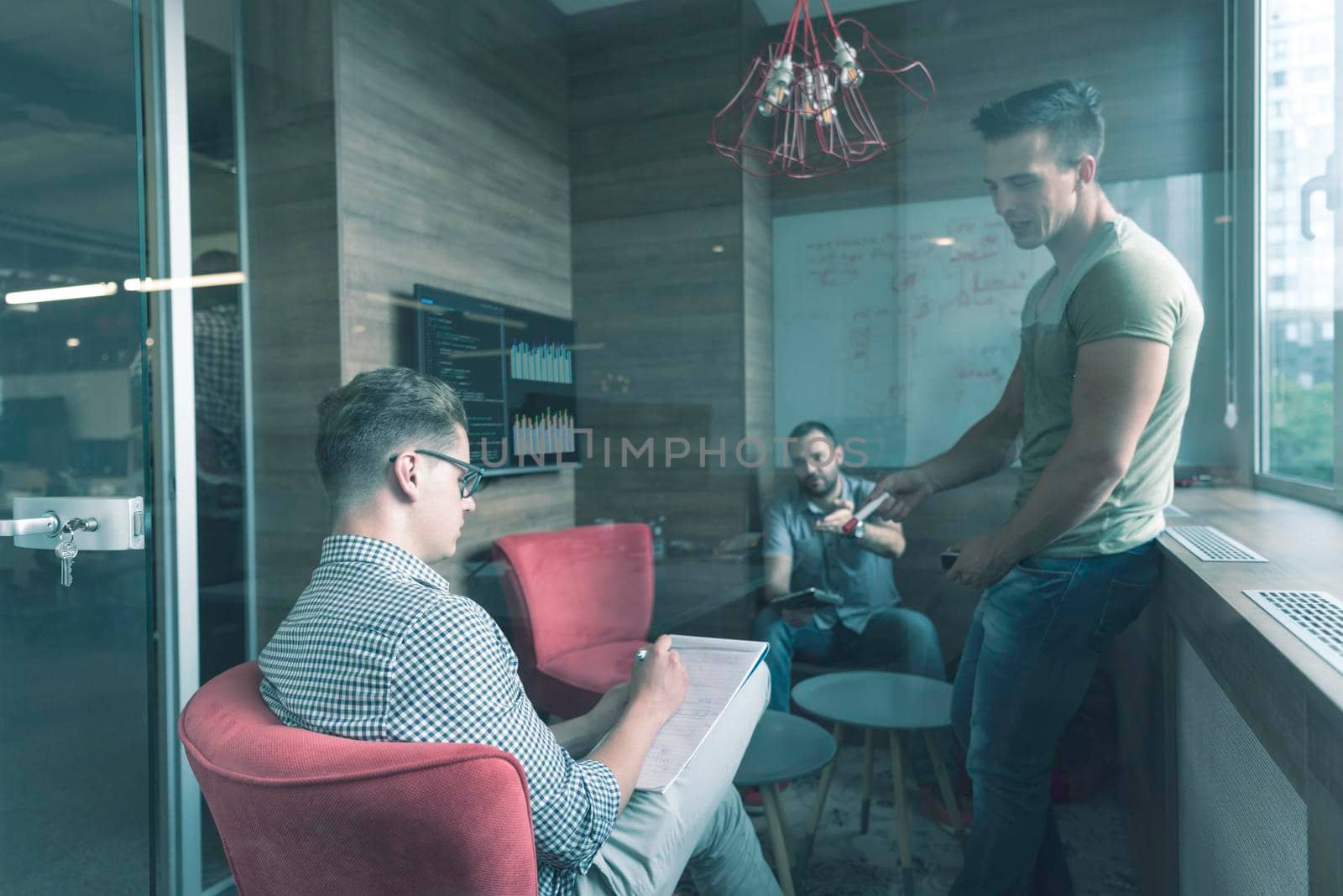 team meeting and brainstorming in small private office by dotshock