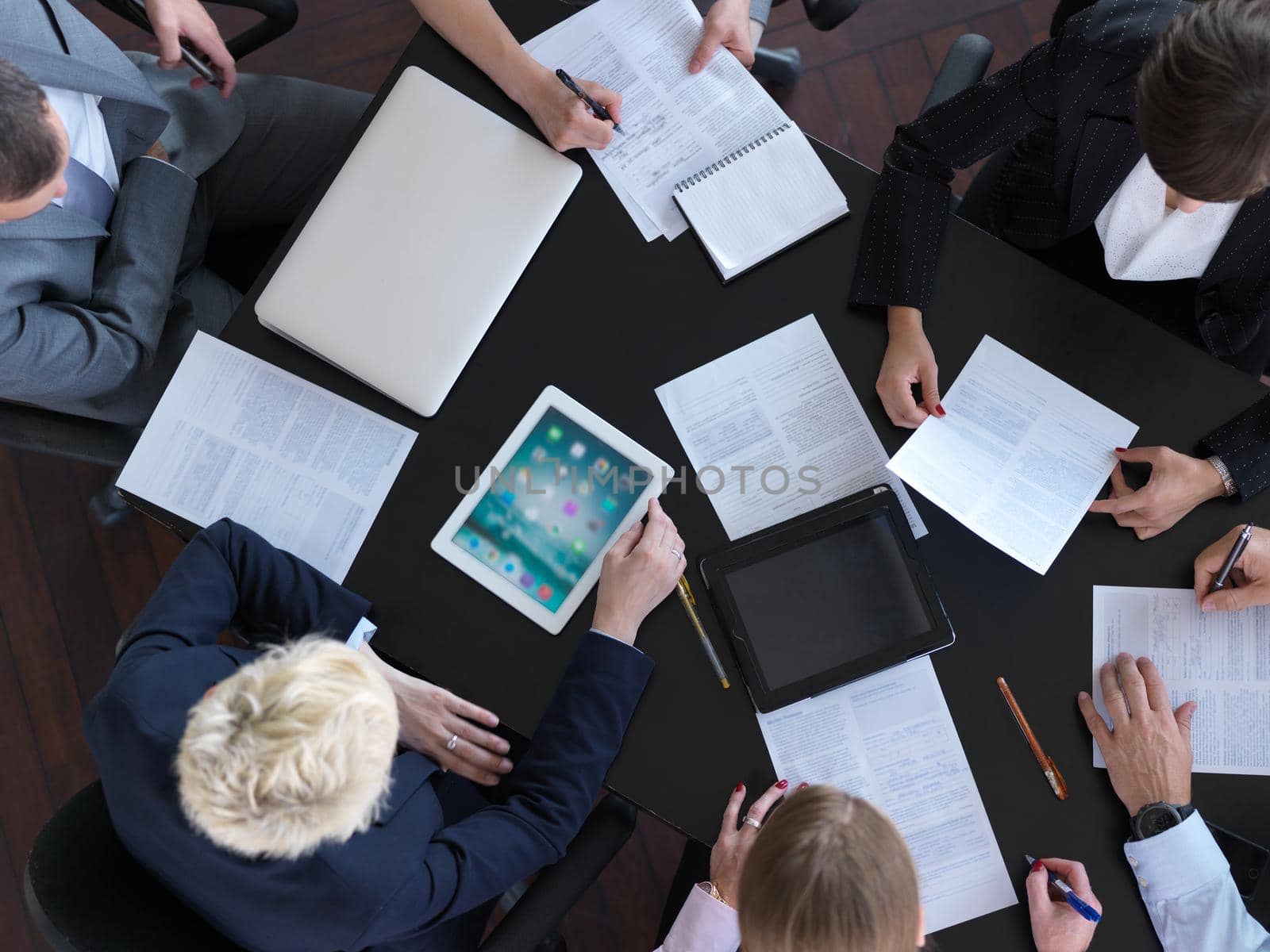 top view of  business people group on meeting, working in modern bright office indoor with tablet computer