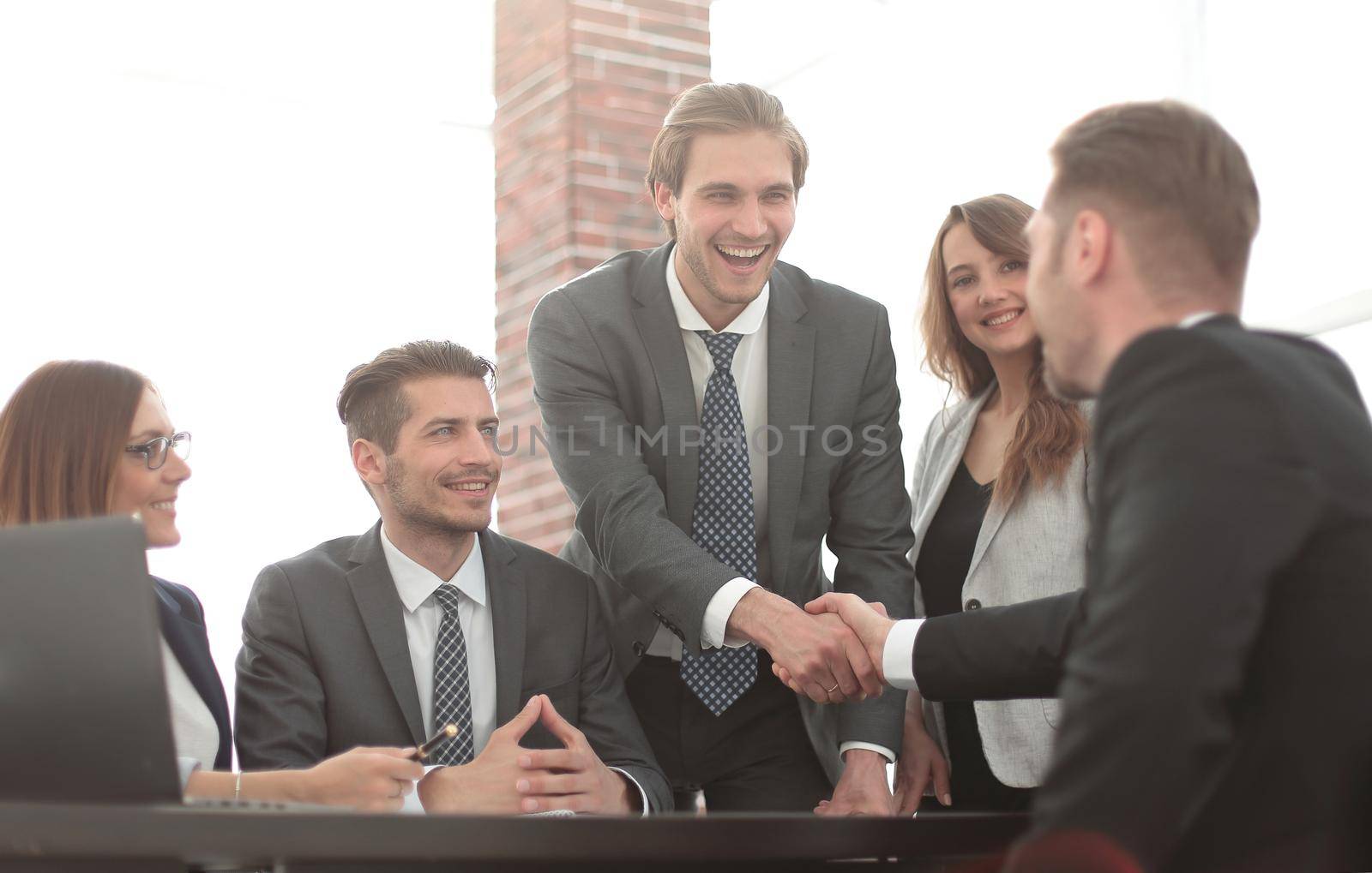 Confident businessmen sitting by table during consultation