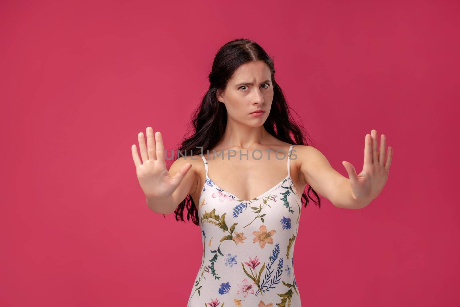 Attractive woman saying thanks but no. Beautiful girl denying proposal, making stop gesture