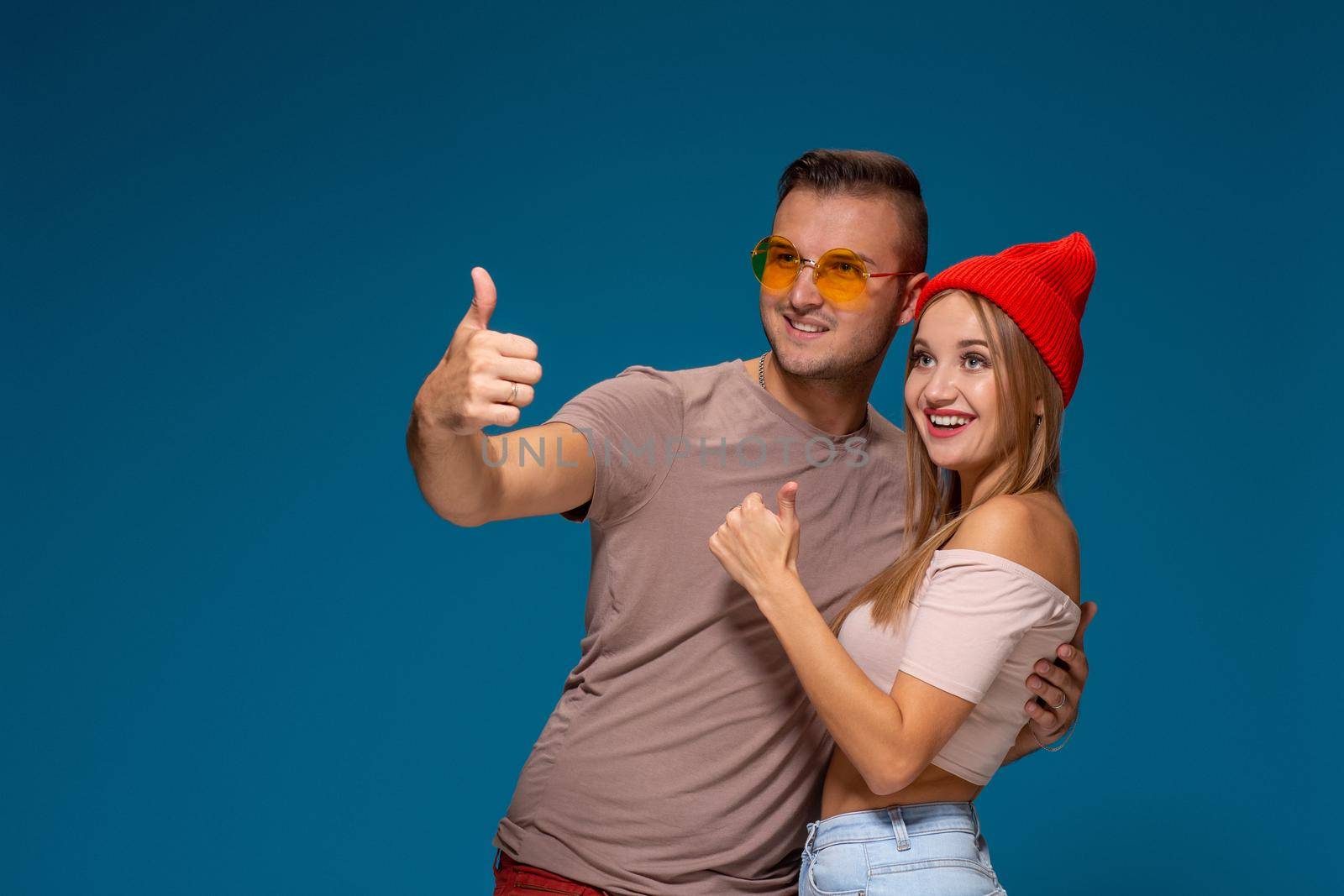 Studio lifestyle portrait of two best friends hipster wearing stylish bright outfits, hats, denim shorts and glasses, going crazy and having great time together. by nazarovsergey