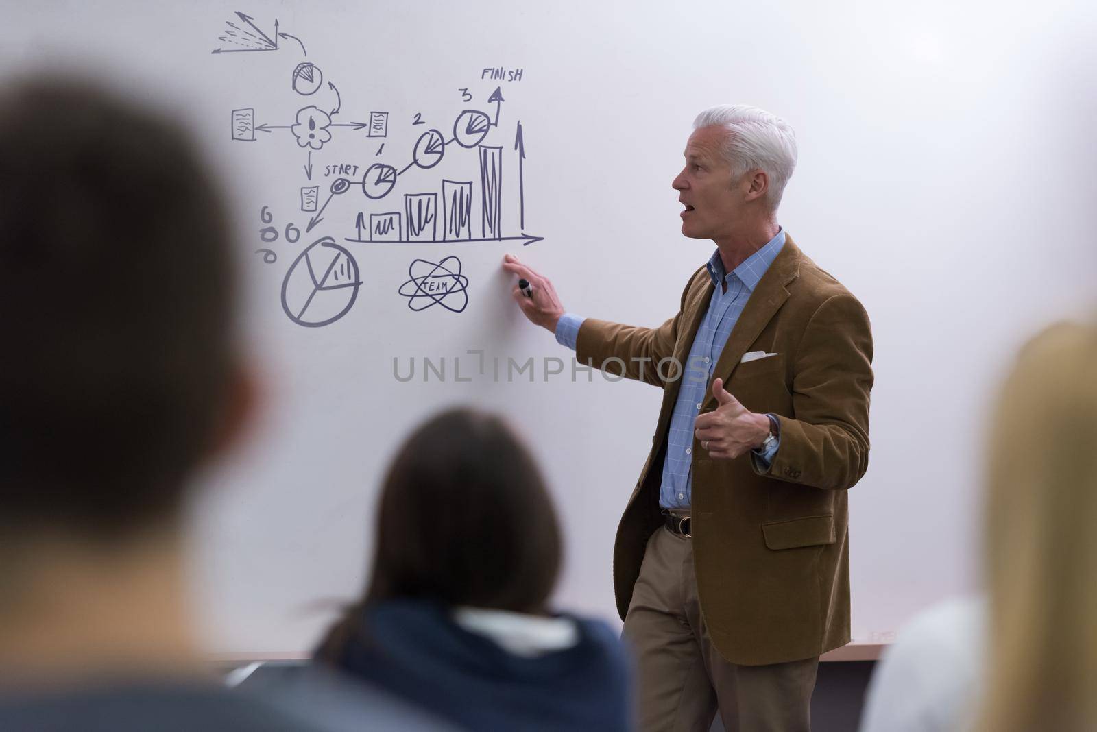 group of students study with professor in modern school classroom