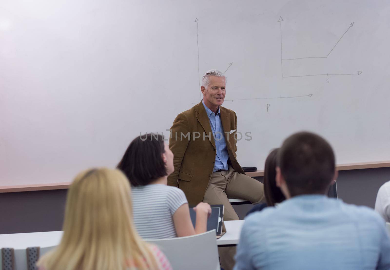 group of students study with professor in modern school classroom