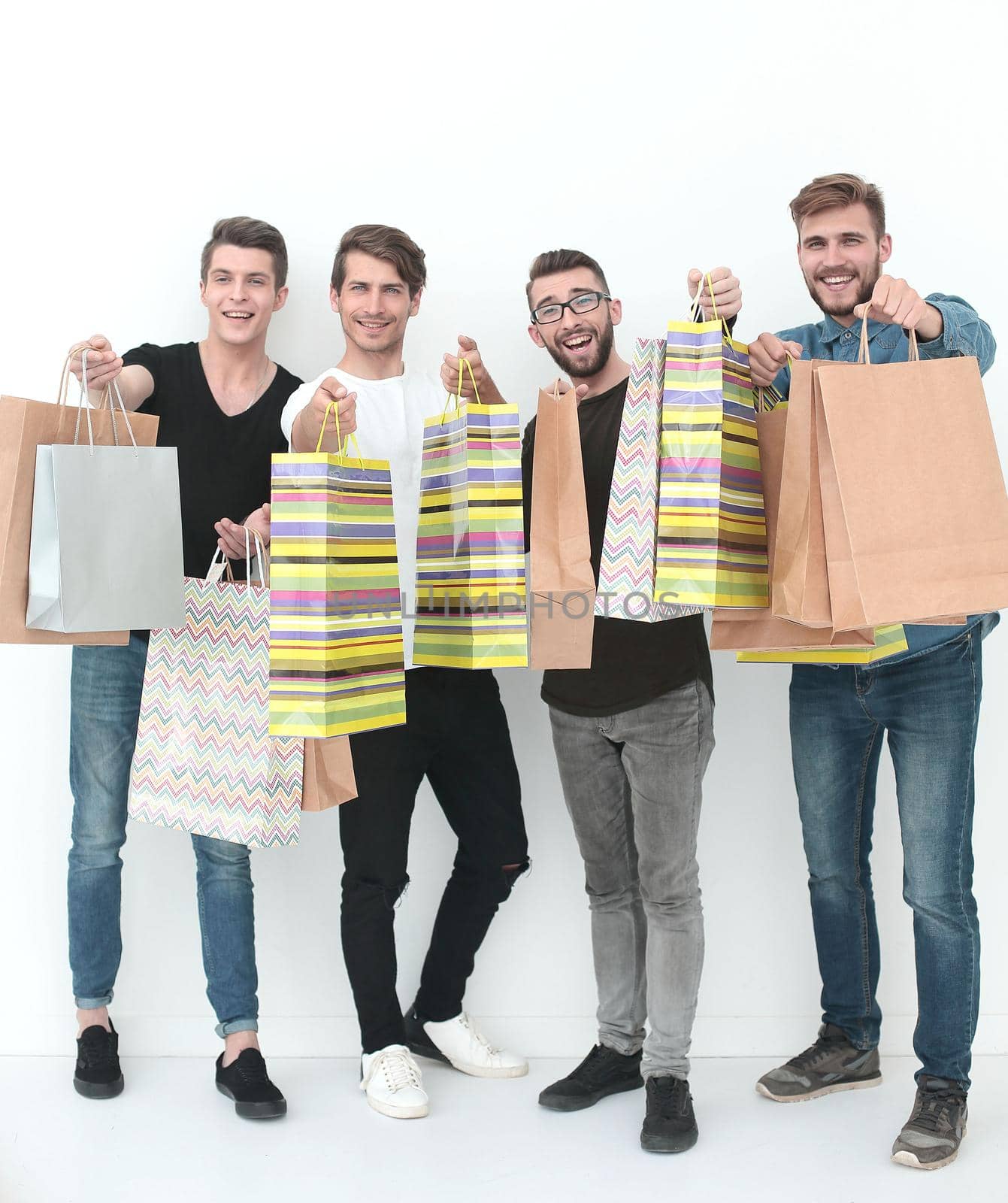 group of young men shows shopping bags. photo with copy space