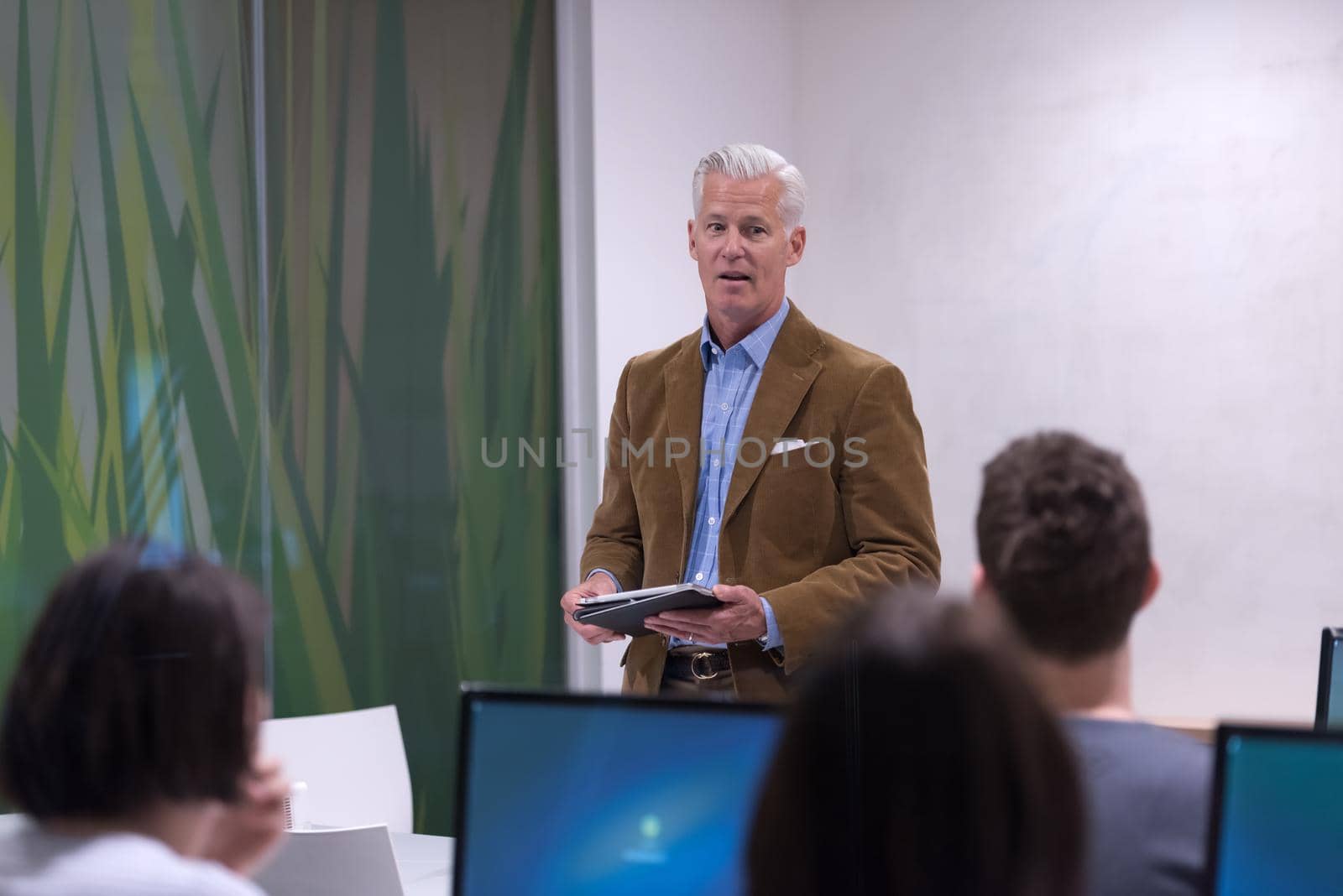 teacher and students in computer lab classroom by dotshock