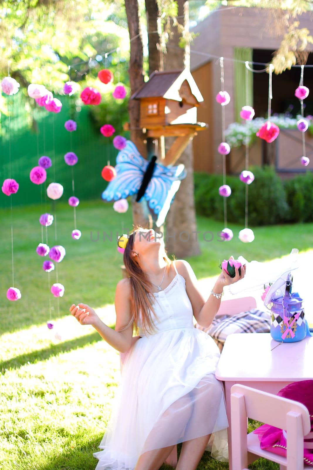 Young caucasian girl playing with bright decorations for summer camp.