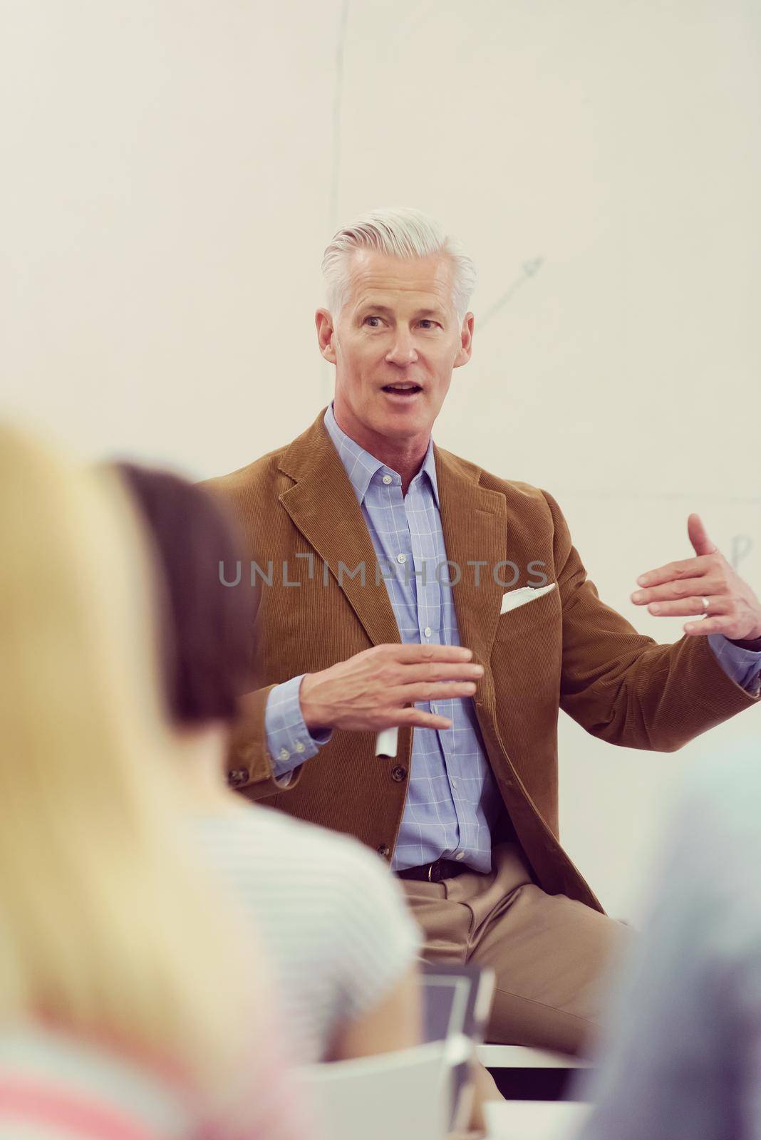 group of students study with professor in modern school classroom