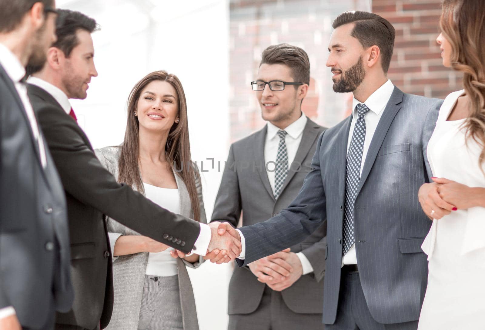 business team looks at the handshake of business partners.the concept of cooperation.