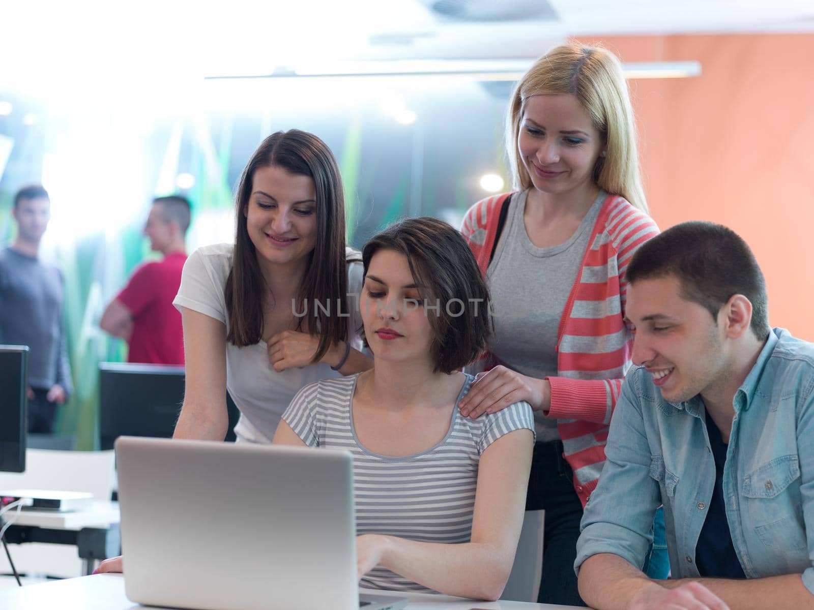 group of students study together in classroom by dotshock