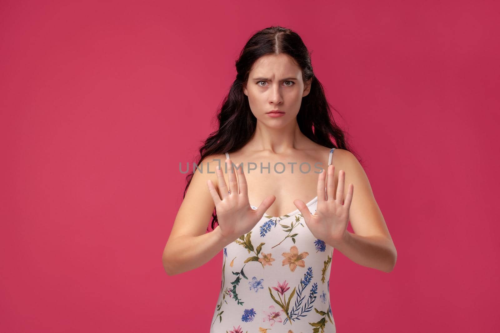 Attractive woman saying thanks but no. Beautiful girl denying proposal, making stop gesture