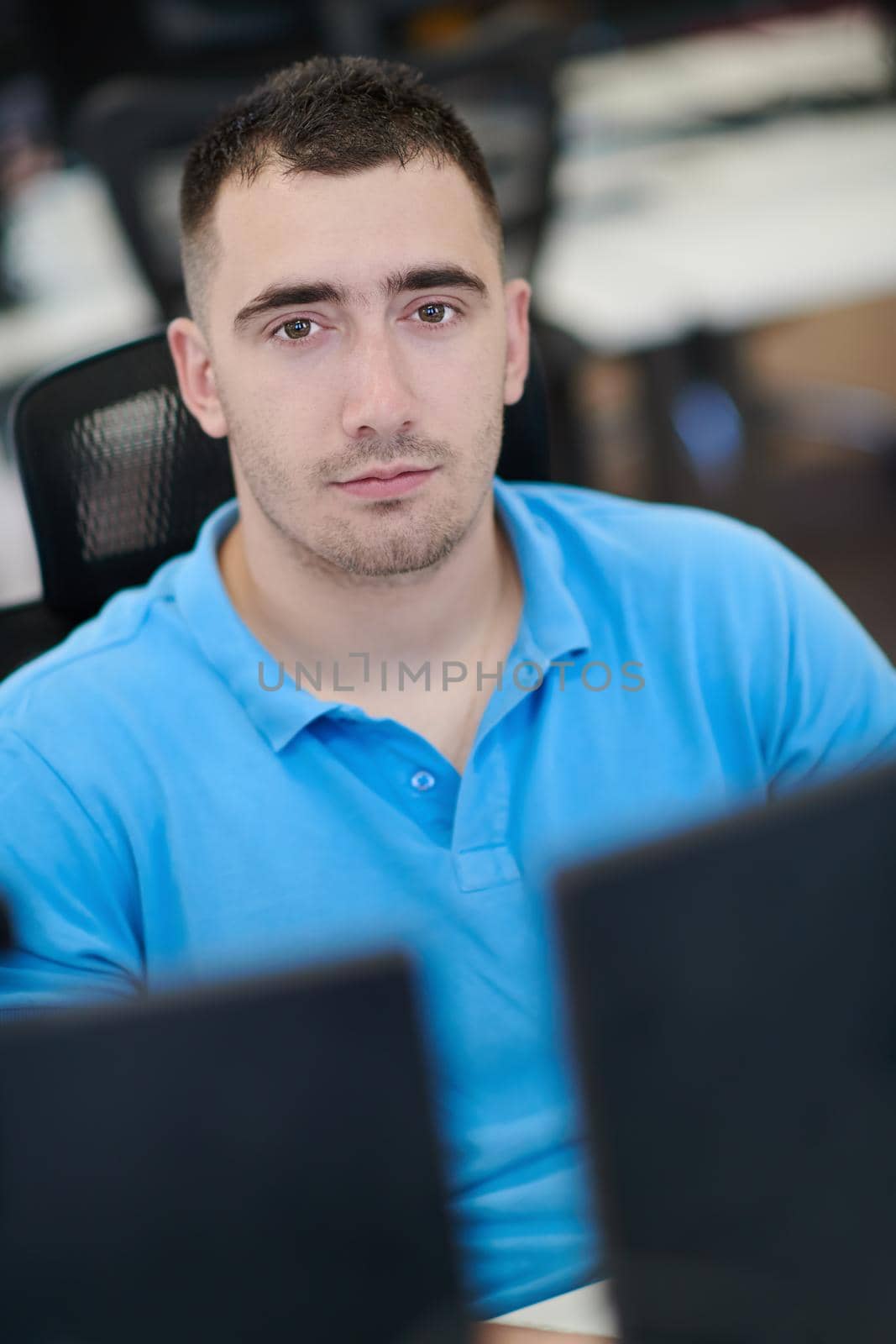 casual business man working on desktop computer in modern open plan startup office interior