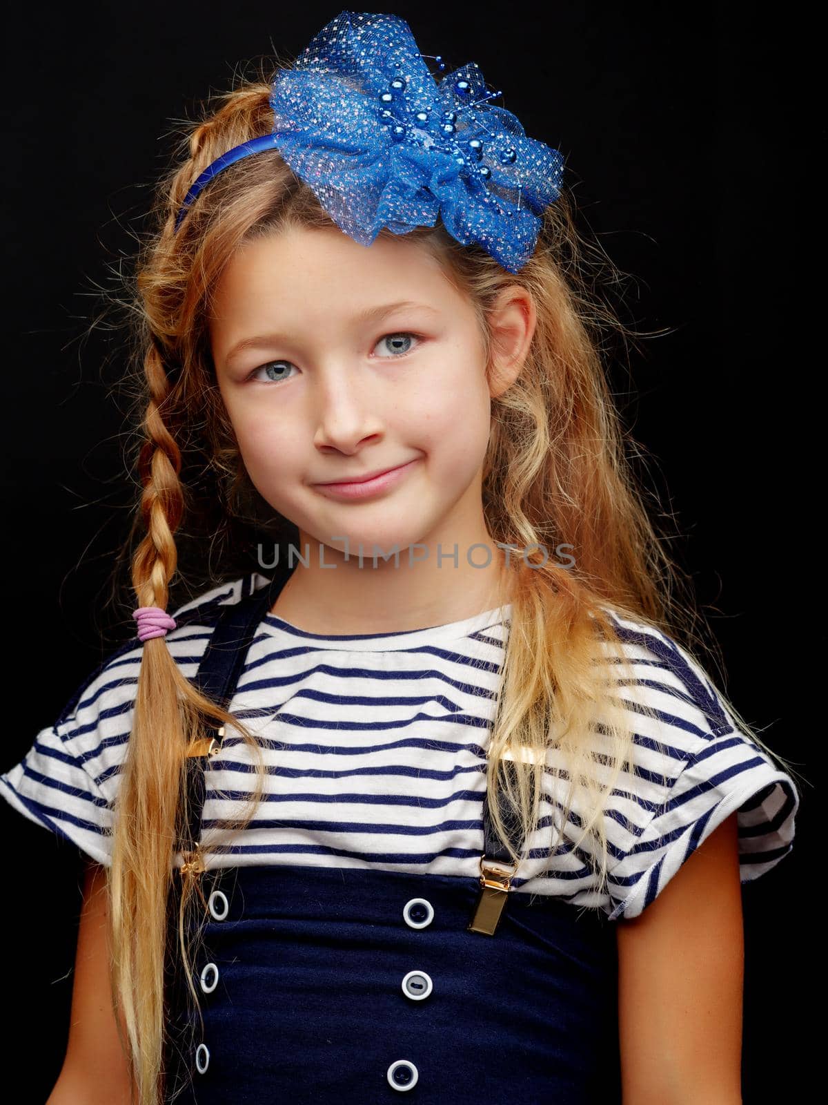 Little little girl studio portrait on a black background. Close- by kolesnikov_studio