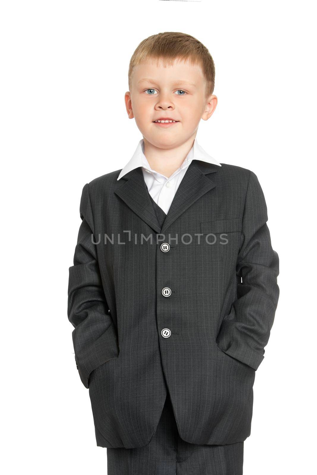 Cute little boy in a suit and white shirt. Put his hands in the pockets of his jacket. Close-up - Isolated on white background