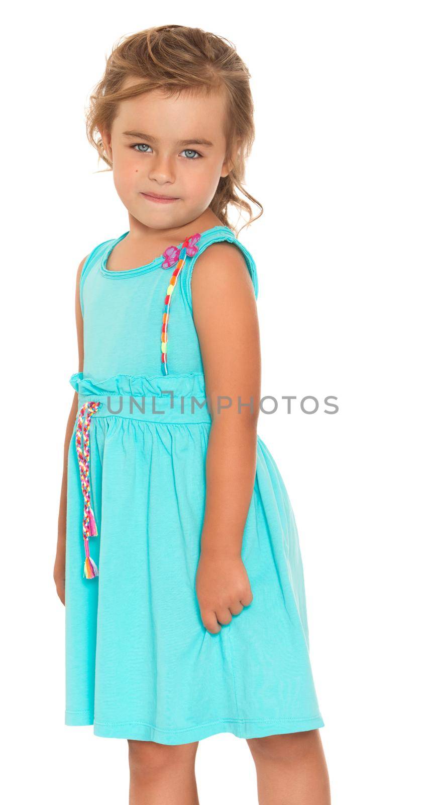Cute little girl with beautiful grey eyes . In the summer blue dress. Takes a step forward. Close-up - Isolated on white background