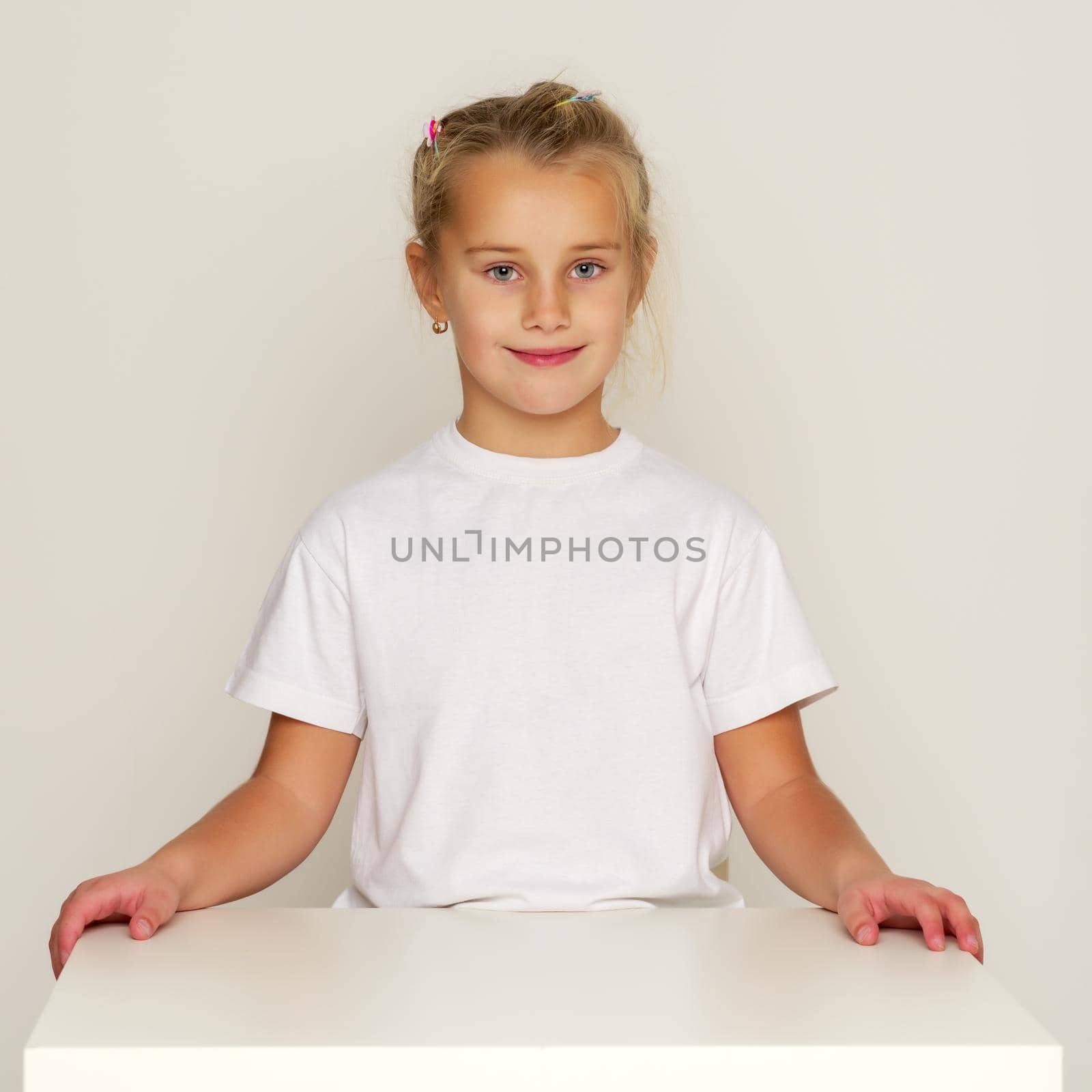Girl schoolgirl sitting at the desk. by kolesnikov_studio