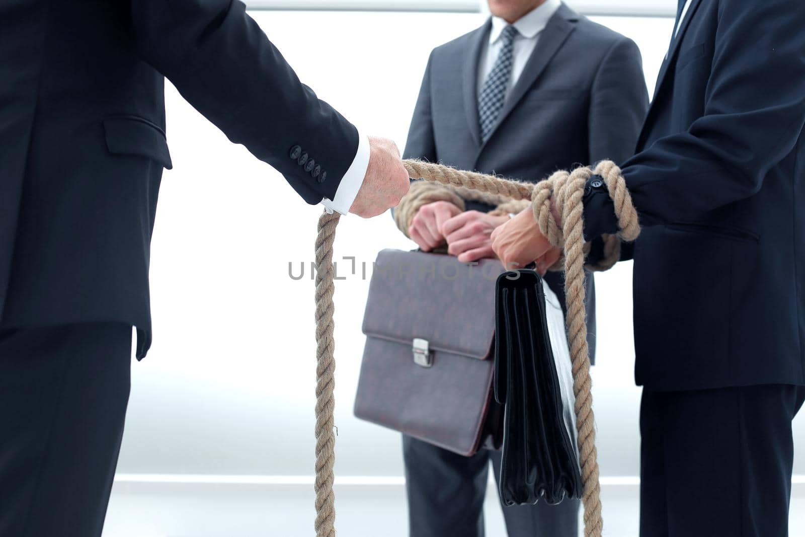 close up. a group of young businessmen tied with a rope .business concept