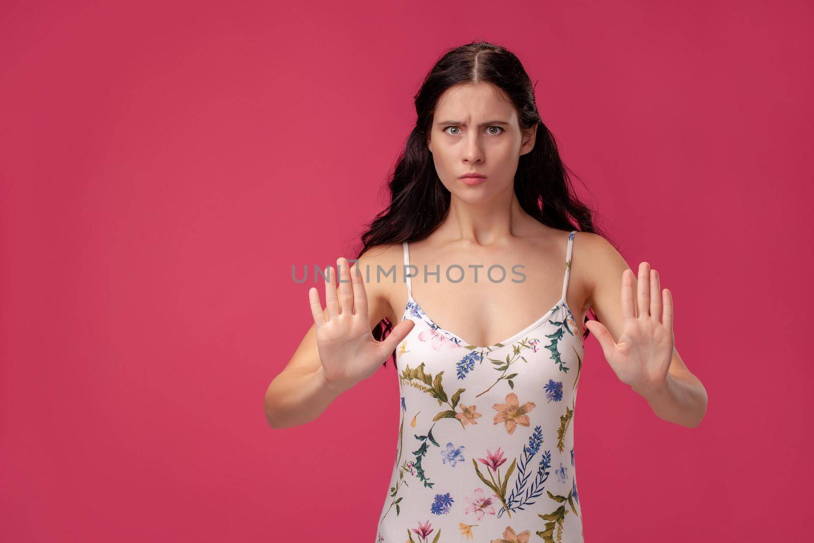 Attractive woman saying thanks but no. Beautiful girl denying proposal, making stop gesture