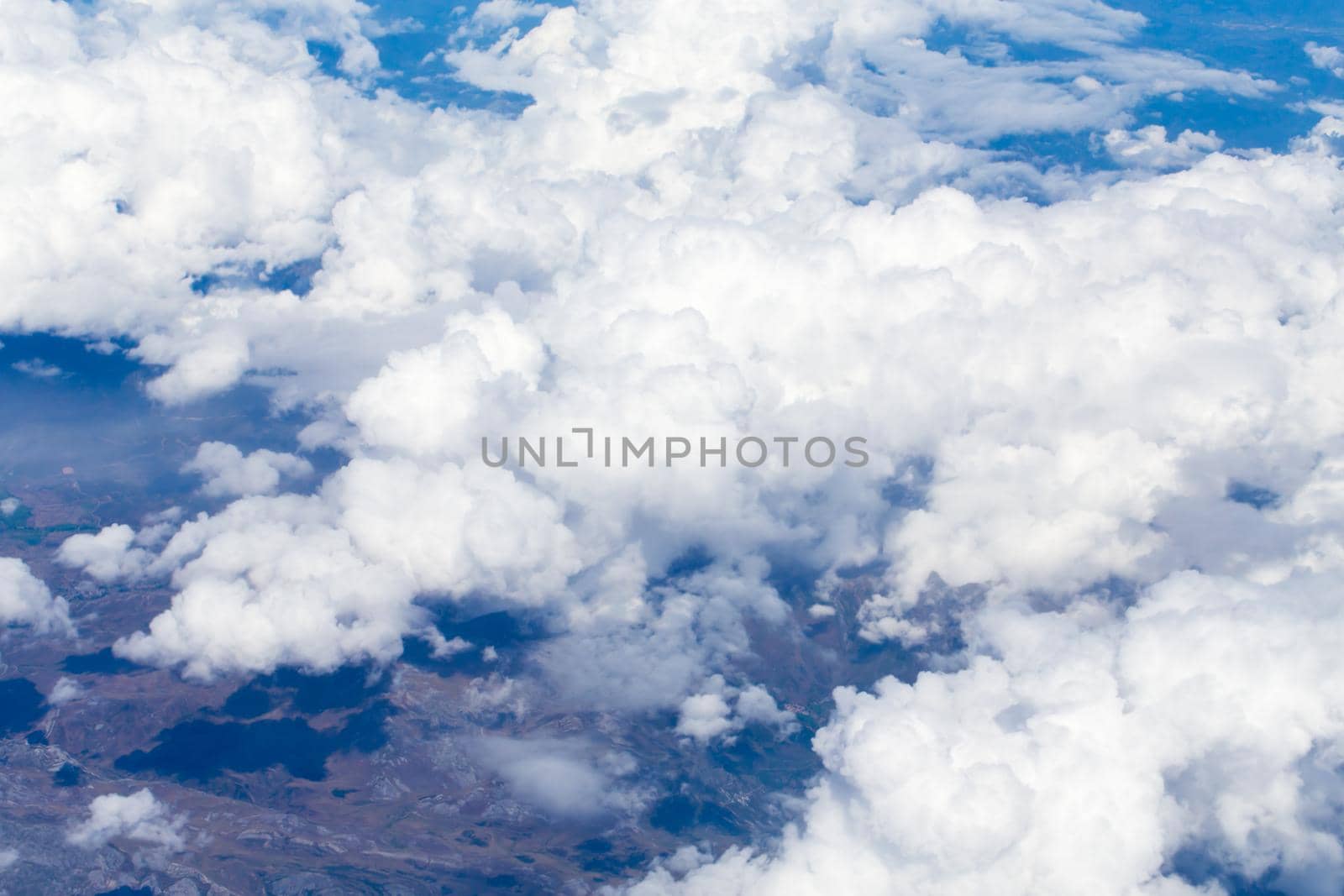 Aerial view from airplane with earth and clouds