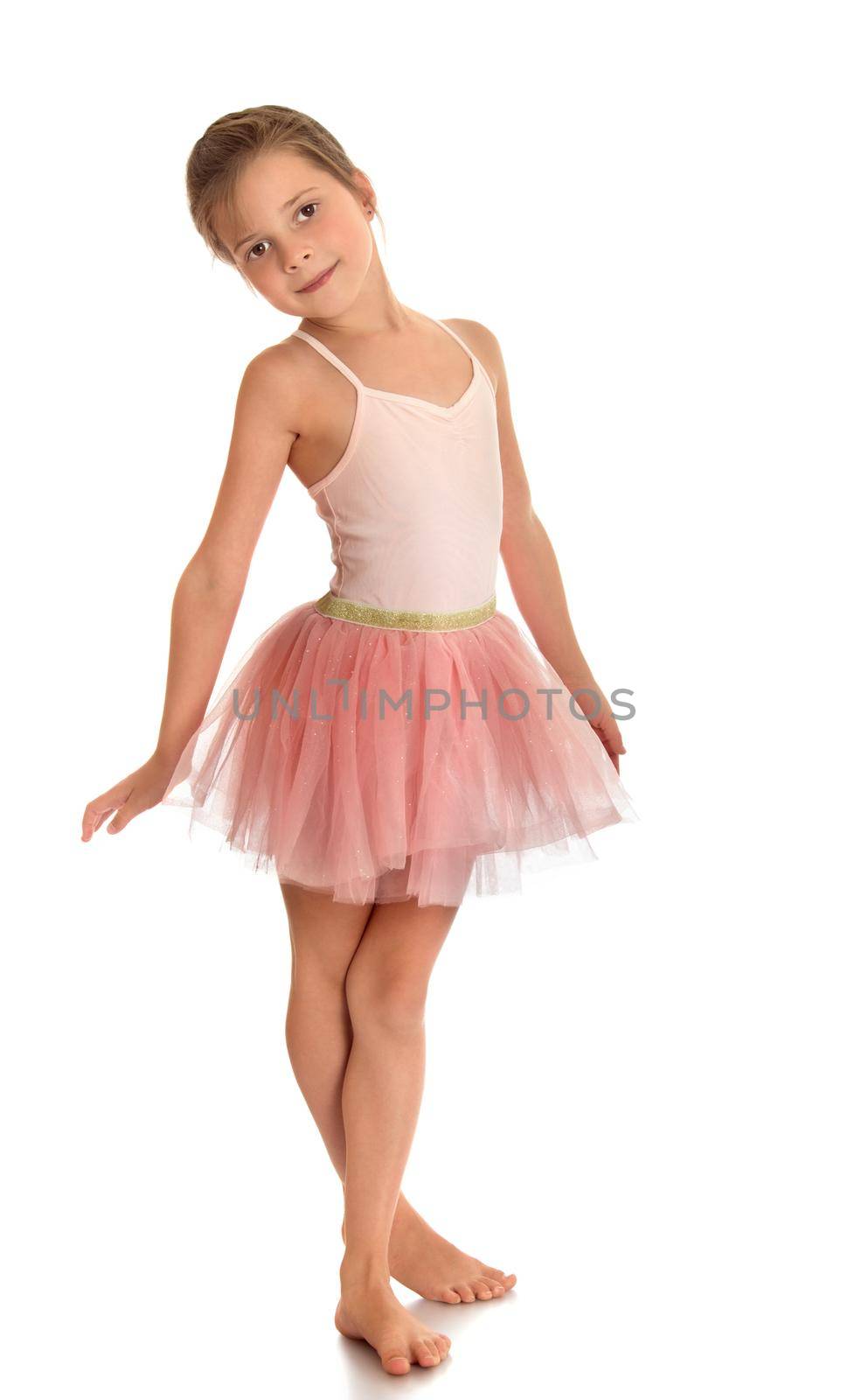 Beautiful barefoot girl gymnast in pink dress . the girl crossed her legs-Isolated on white background