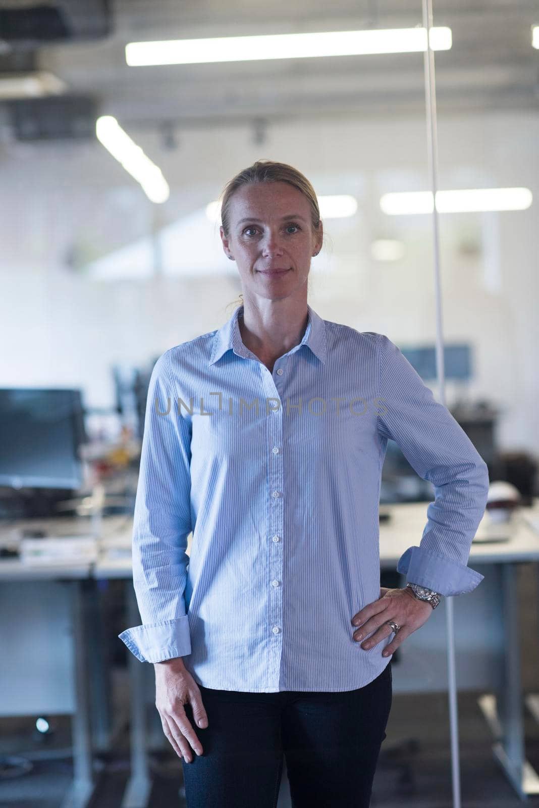 portrait of casual business woman at office by dotshock