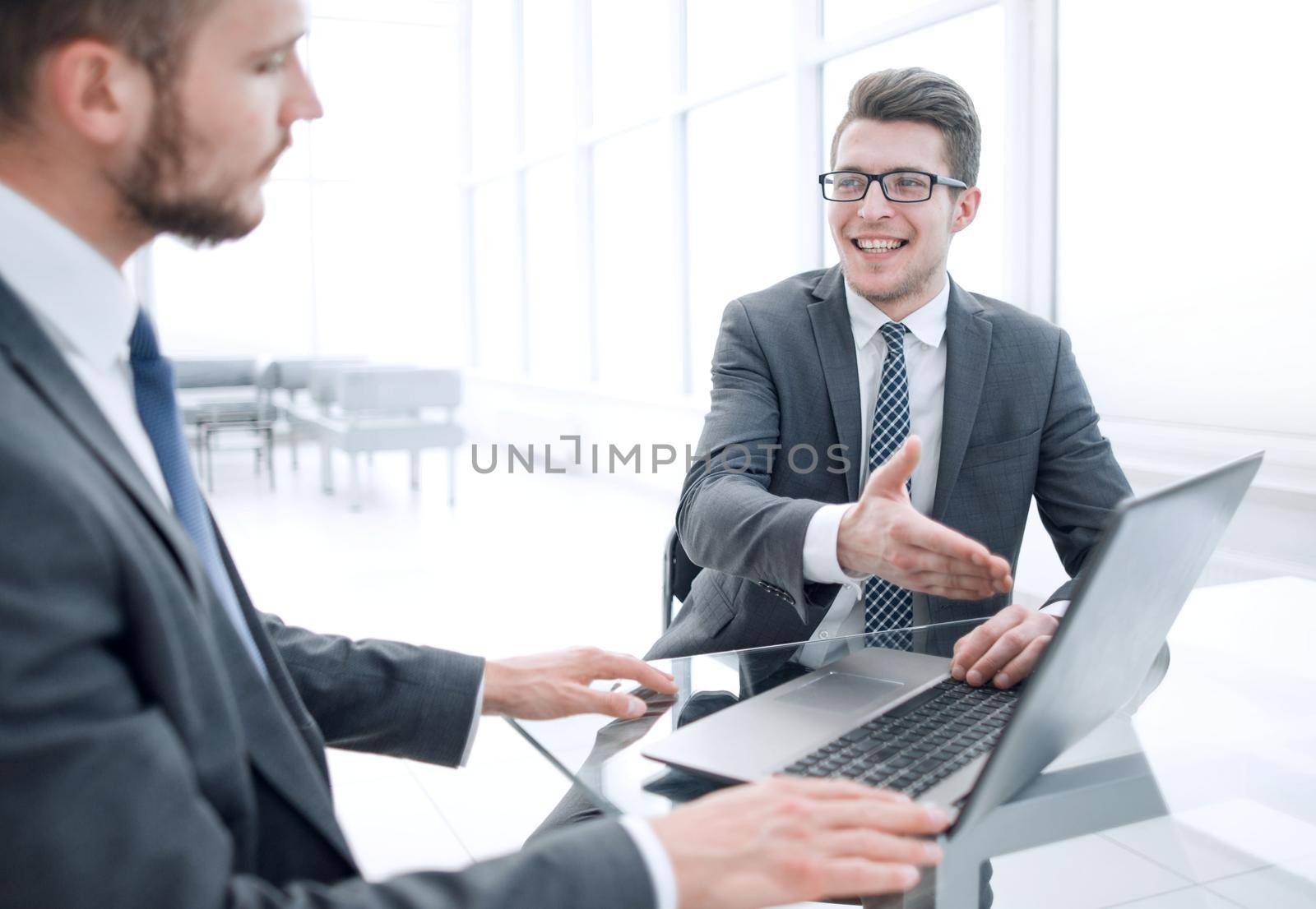 close up.business partners discuss information sitting at the office table.people and technology