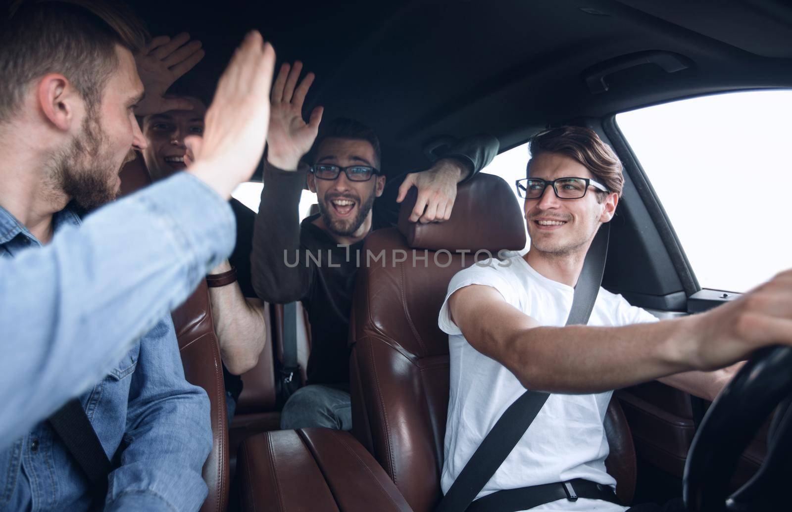 close up.happy friends talking in the car. by asdf