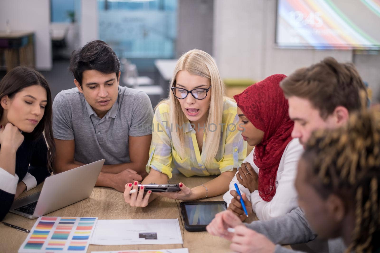 Multiethnic startup business team having meeting by dotshock