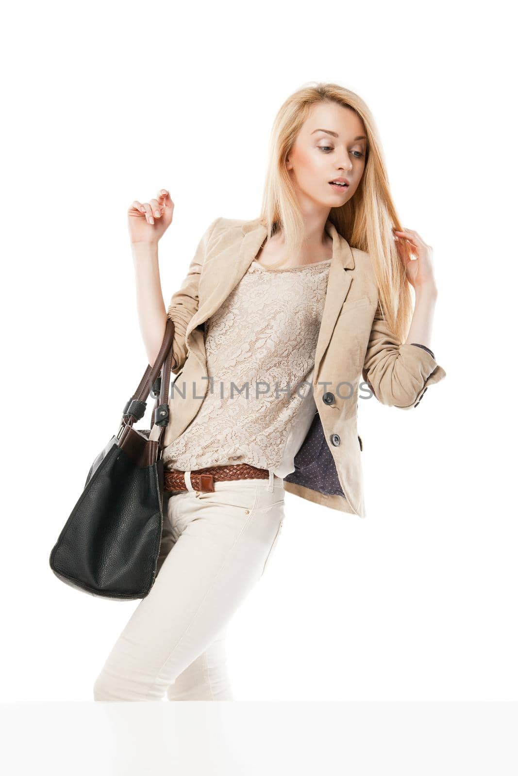 Young excited woman looking at the shop window isolated over white