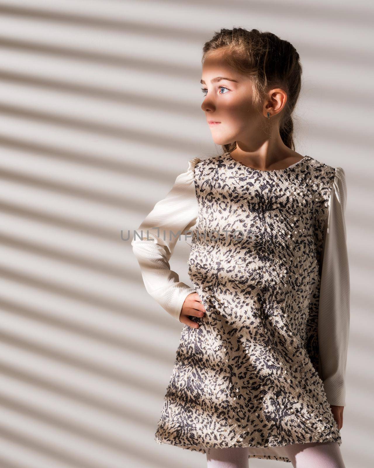 Portrait of a little girl in the rays of light. by kolesnikov_studio