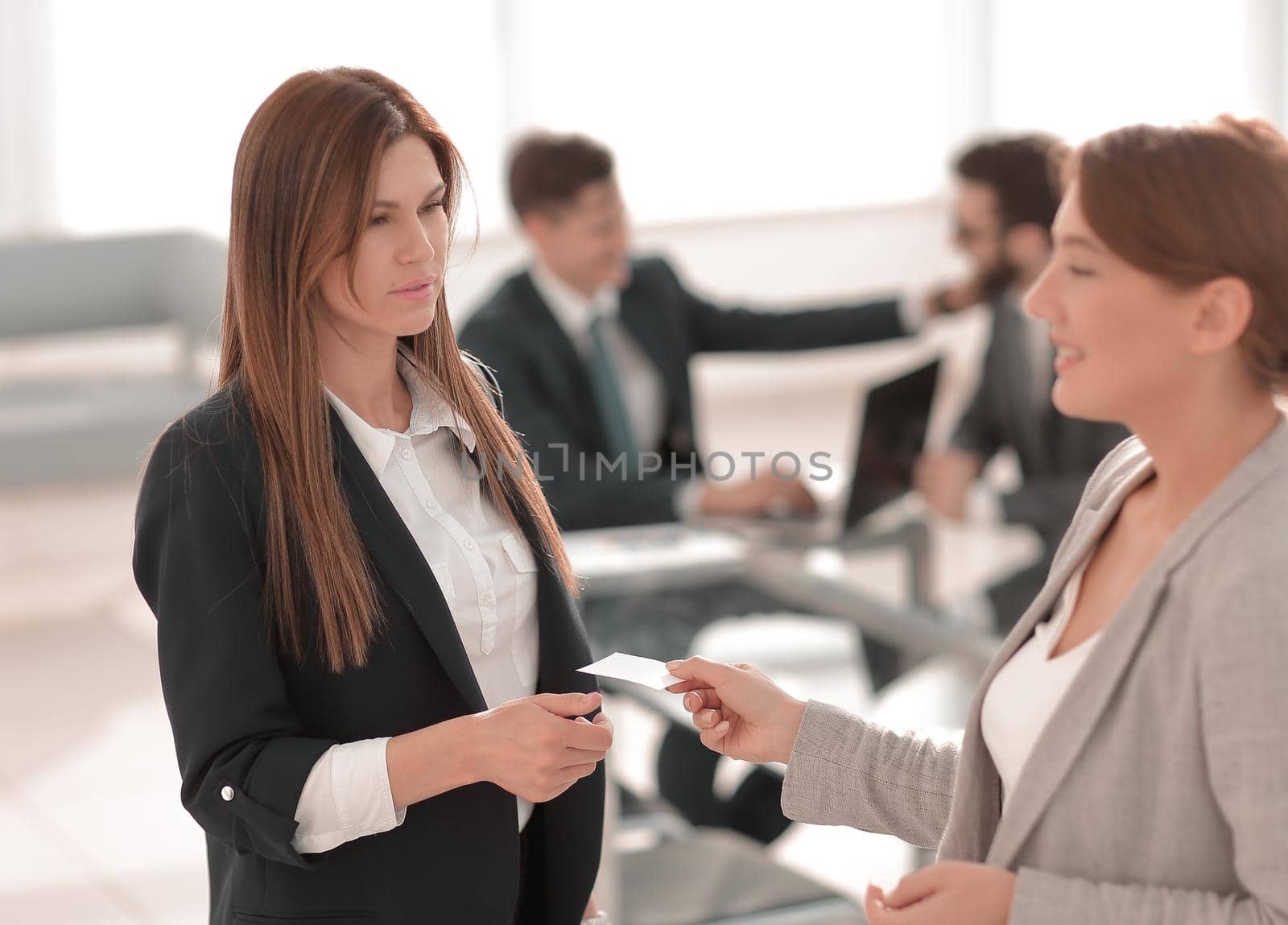 successful business woman gives her business card by asdf