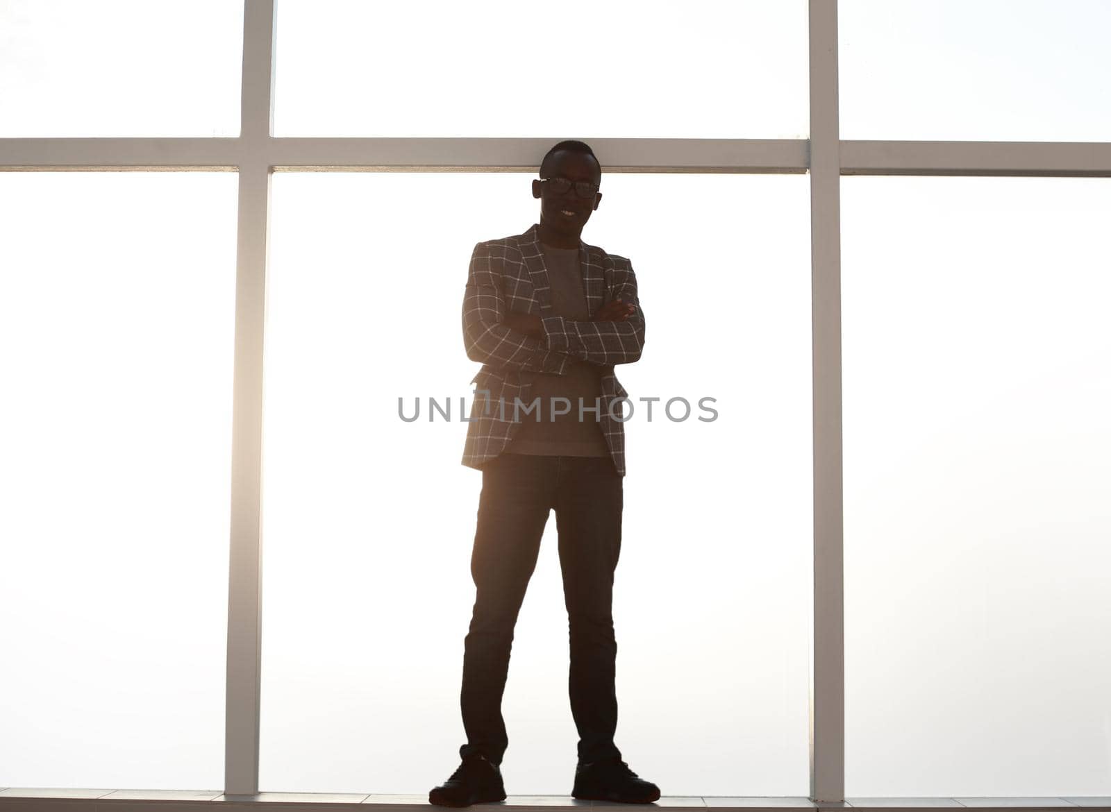 background image. businessman standing near the window. photo with copy space