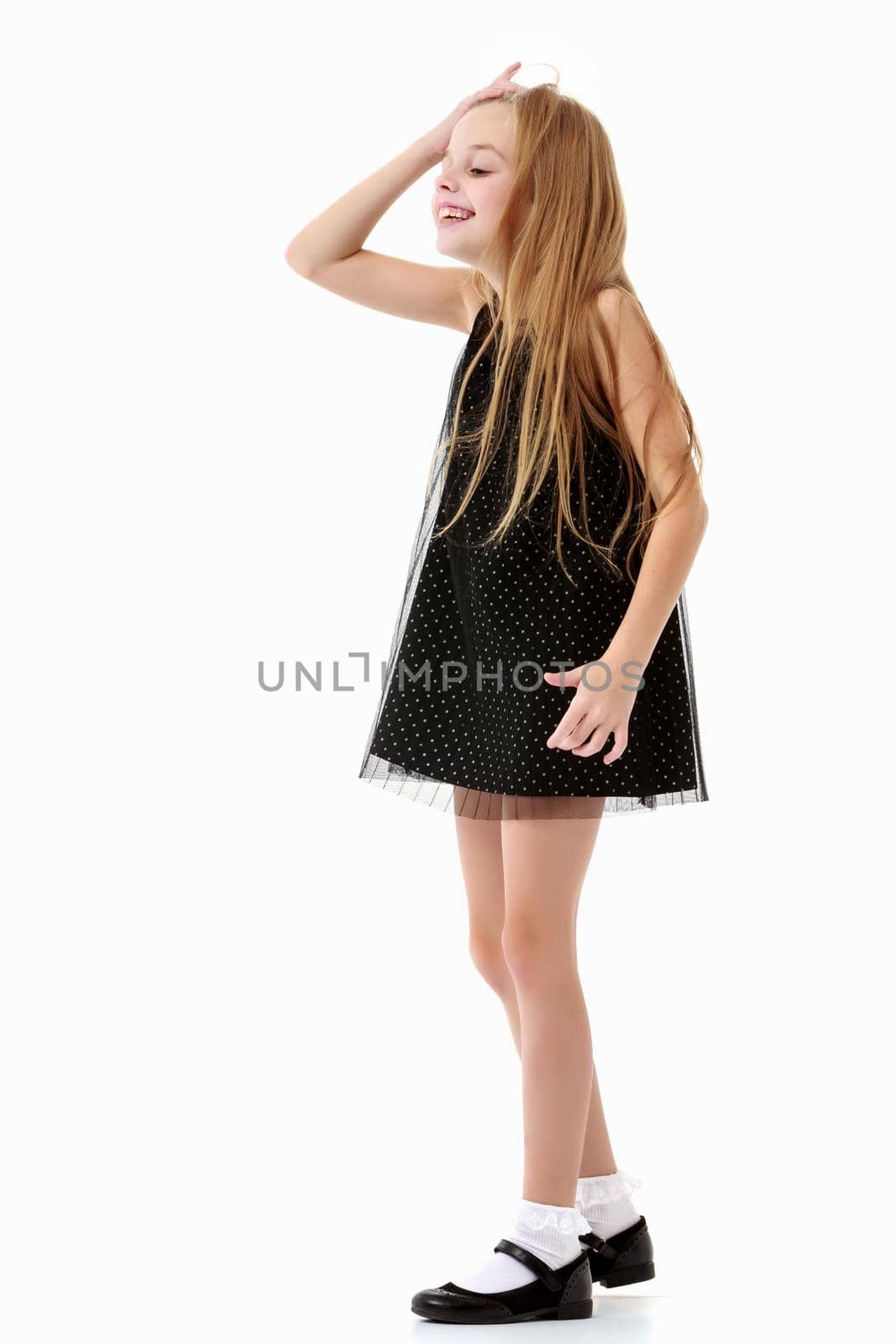 A sweet girl straightens her hair. The concept of fashion and style. Isolated over white background