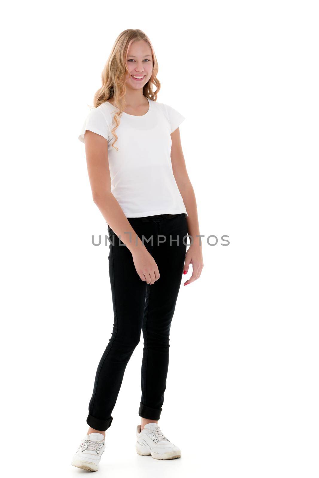 A little school girl in a white empty T-shirt. The concept of advertising and design of T-shirts. Isolated on white background.