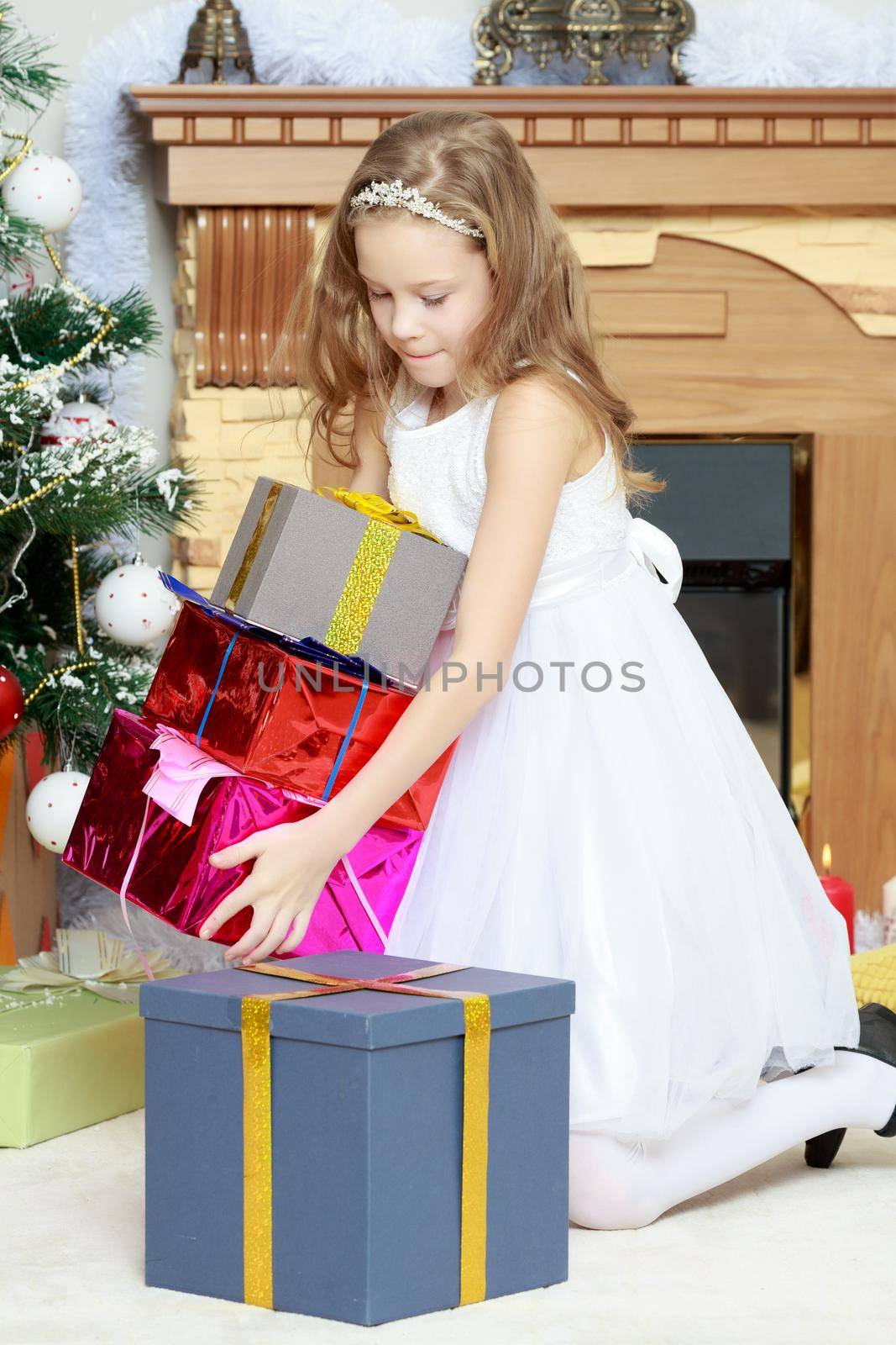 Little Princess with a gift by the Christmas tree. by kolesnikov_studio