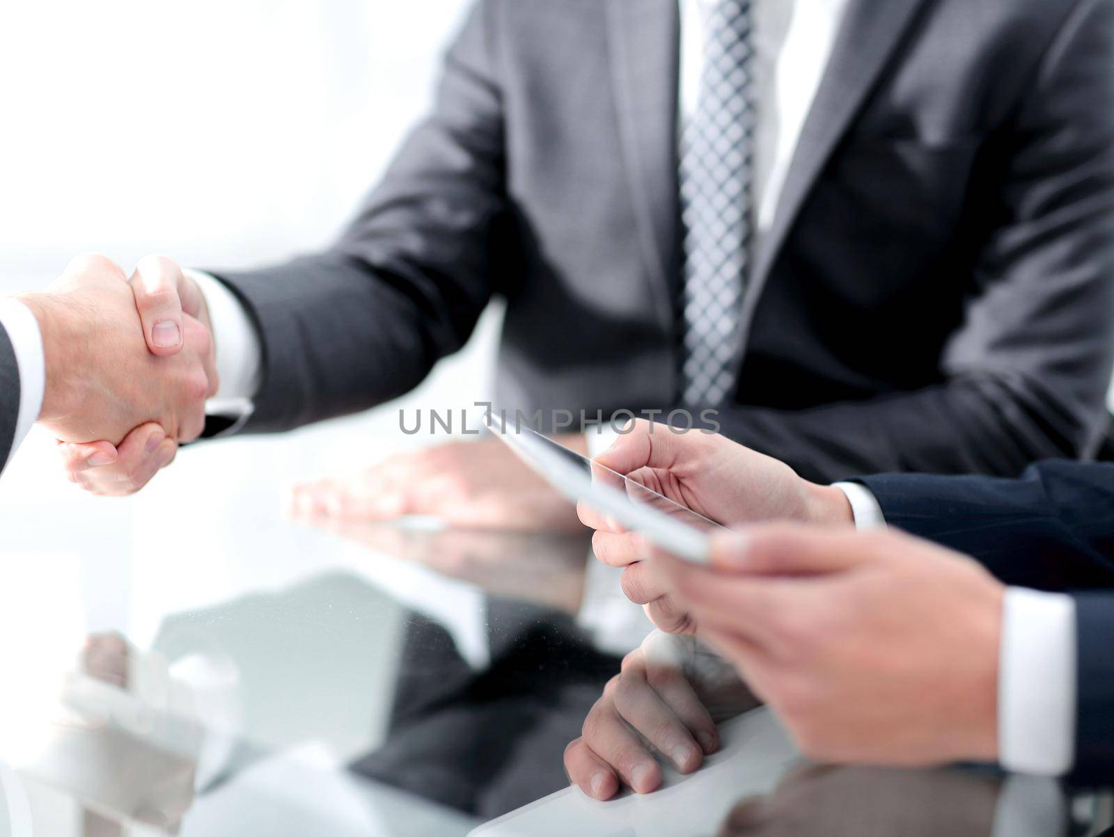 handshake business colleagues in office