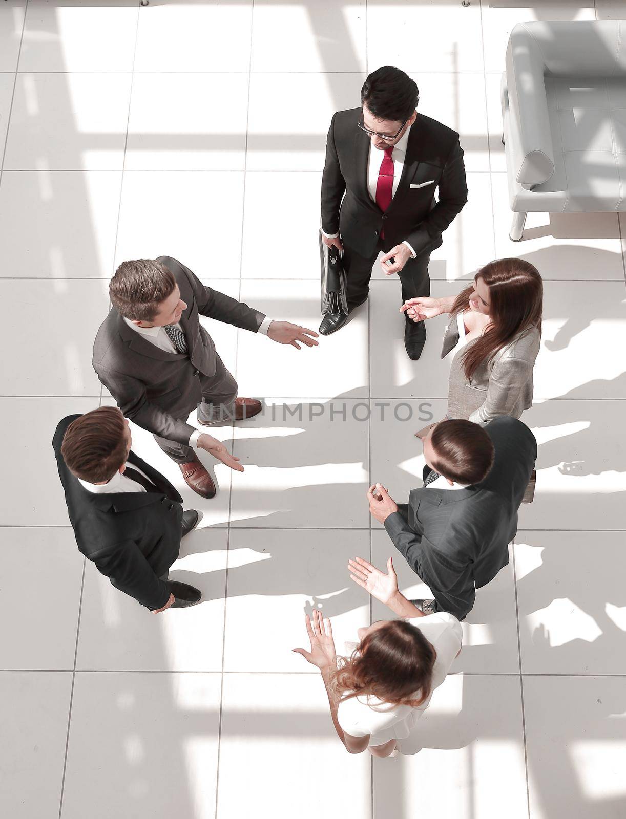 top view.a group of business people talking standing in the hall. business concept