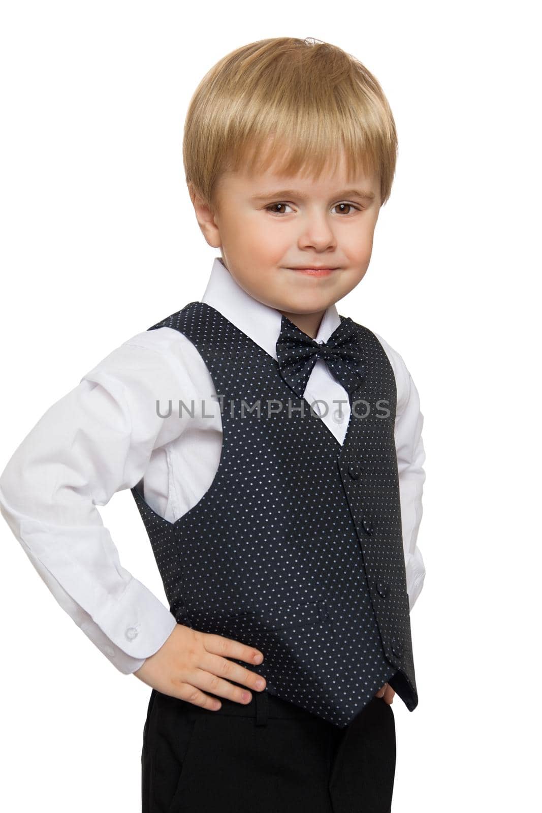 Cute little boy in white shirt, vest and tie , turned the camera sideways - Isolated on white background