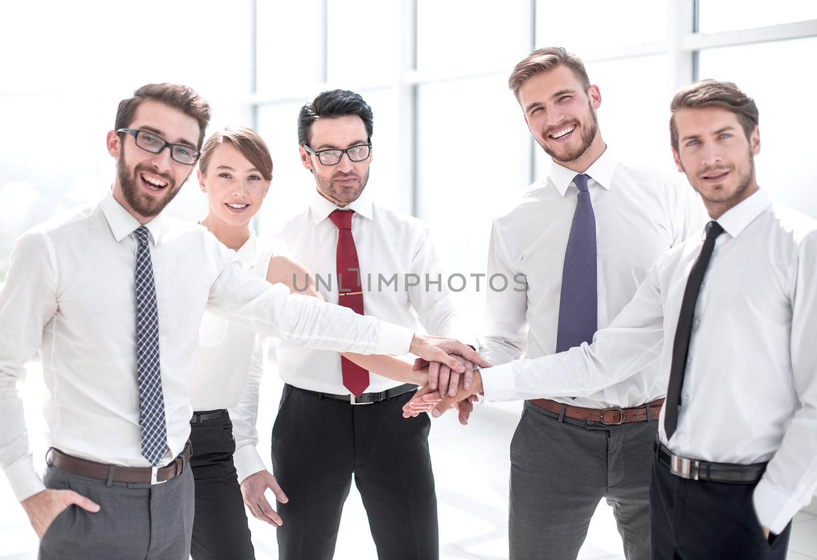 successful business team holding hands .the concept of unity