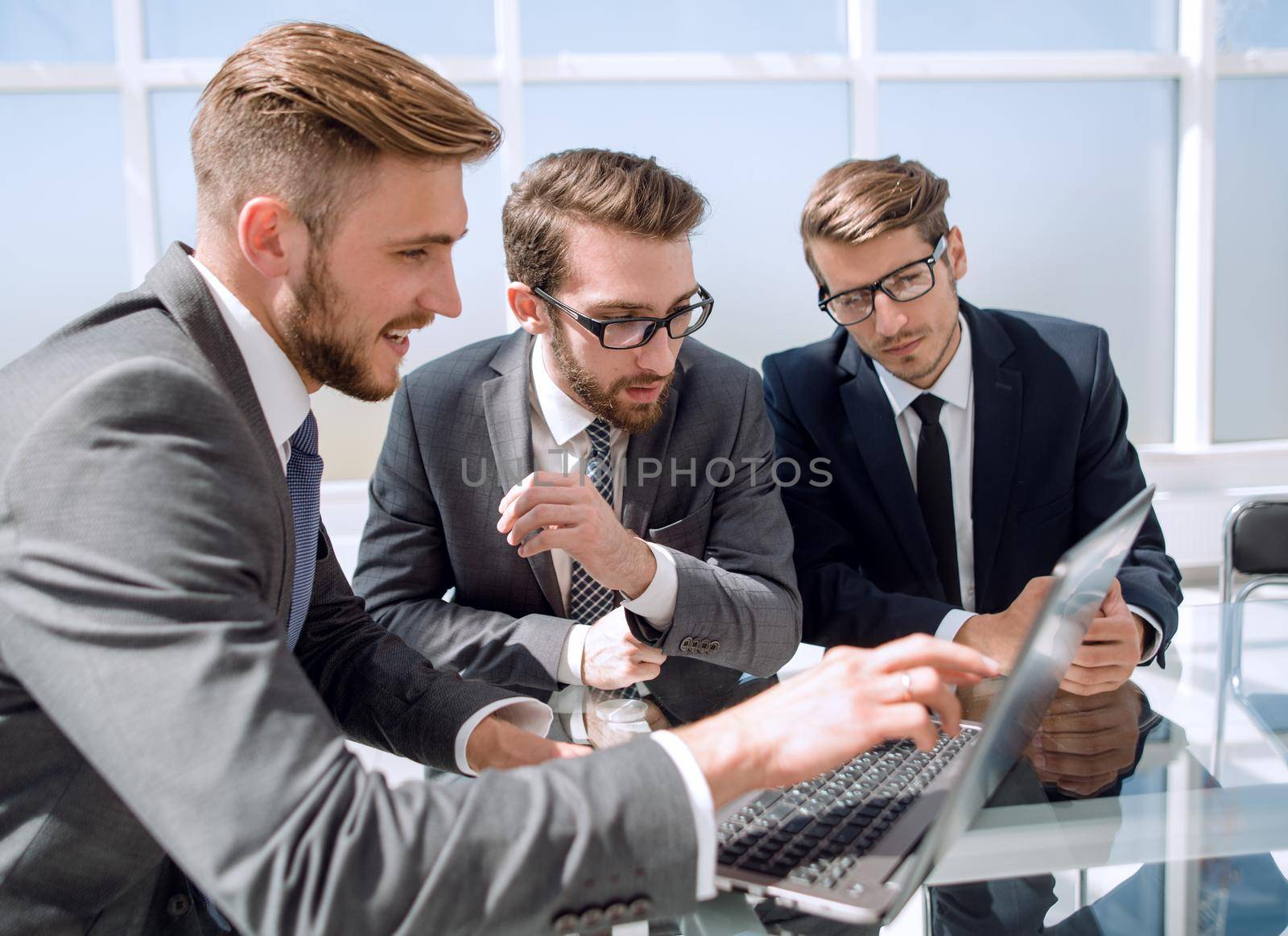 three businessman sitting at his Desk.business and technology
