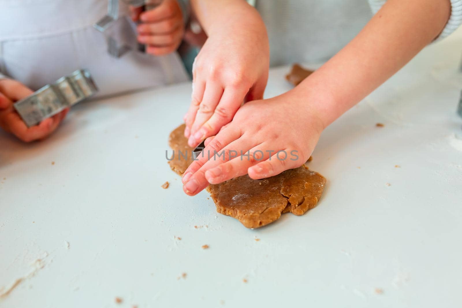 Christmas bakery. Friends making gingerbread, cutting cookies of gingerbread dough, view from above. Festive food, cooking process, family culinary, Christmas and New Year traditions concept