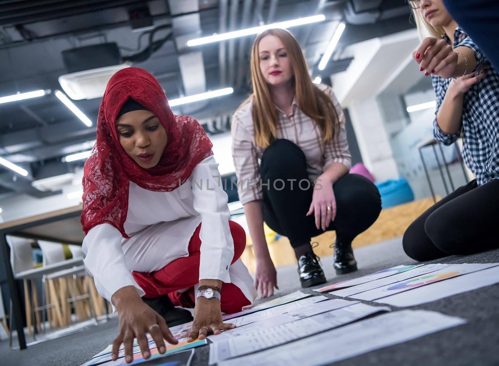 black muslim woman having meeting with Multiethnic  startup business team by dotshock