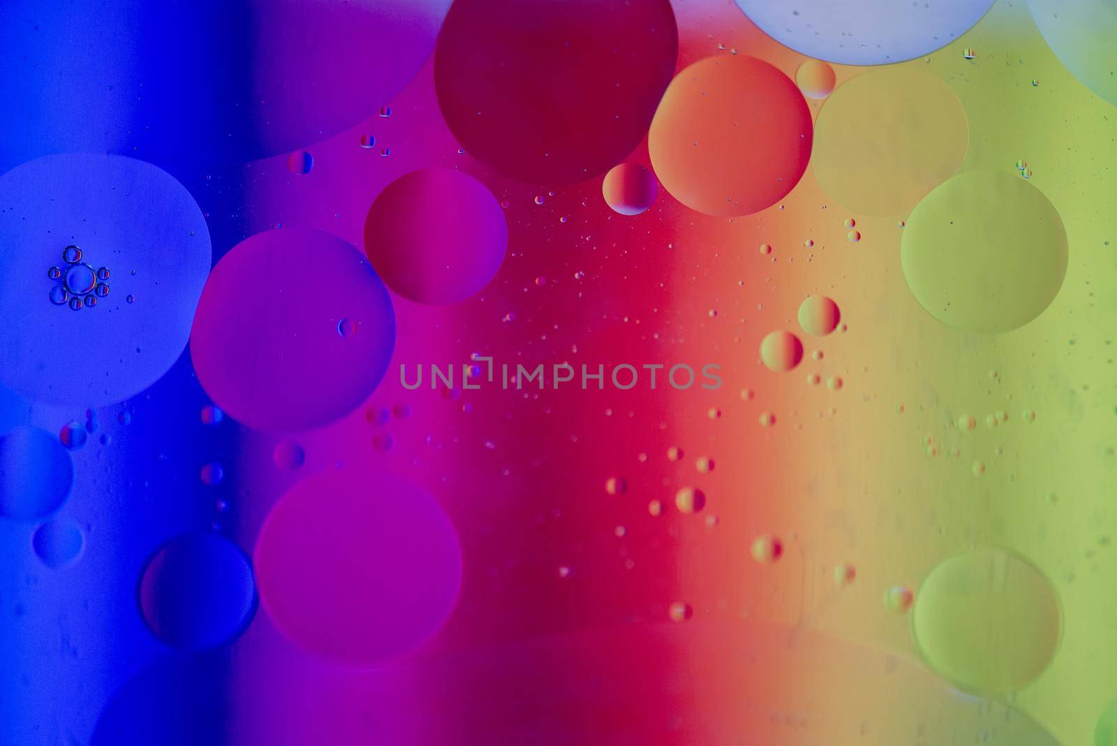 Oil drops in water. Abstract defocused psychedelic pattern image rainbow colored. Abstract background with colorful gradient colors. DOF