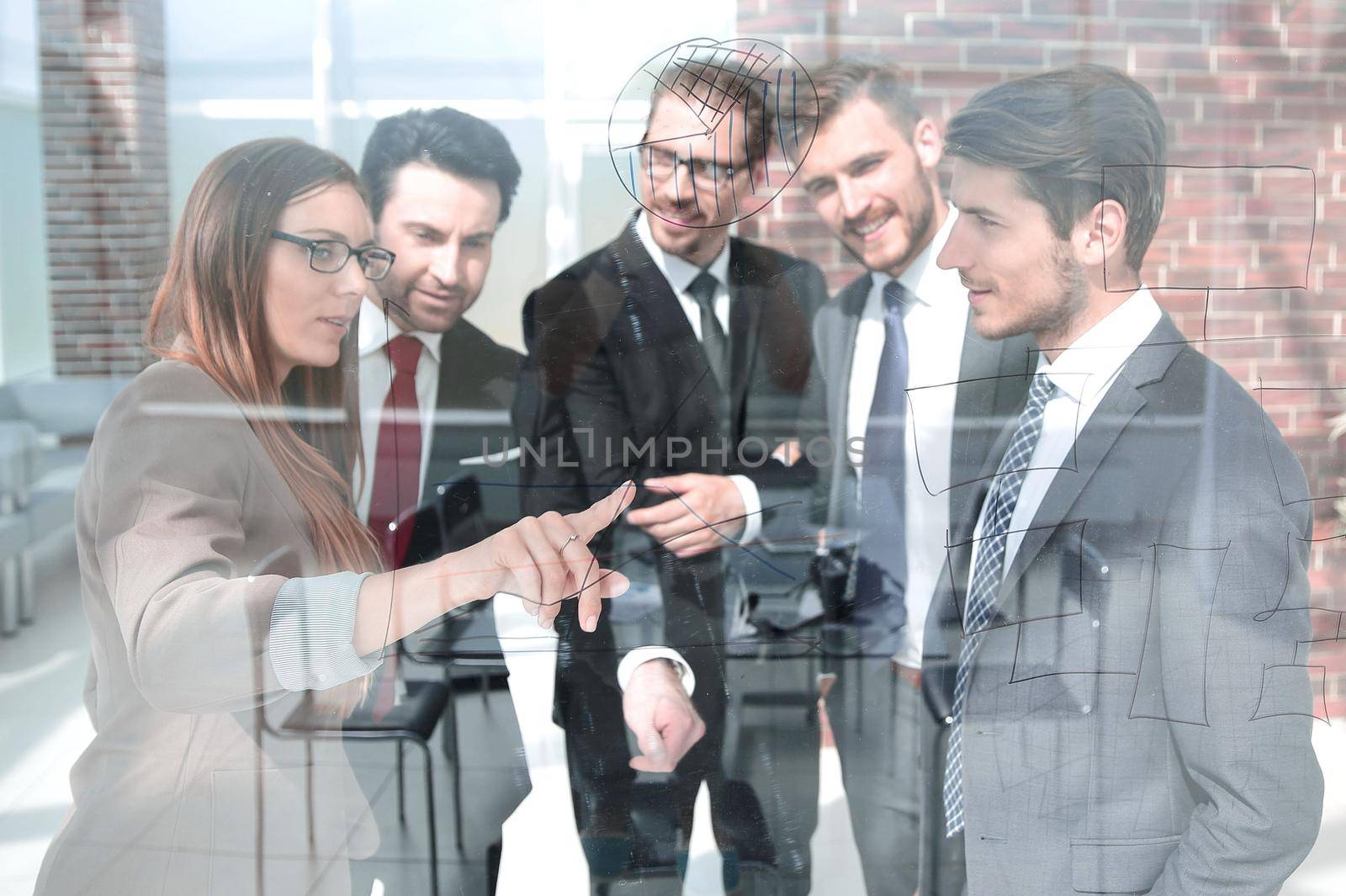 Wide angle of business meeting in modern office behind glass windows, shot from outside building