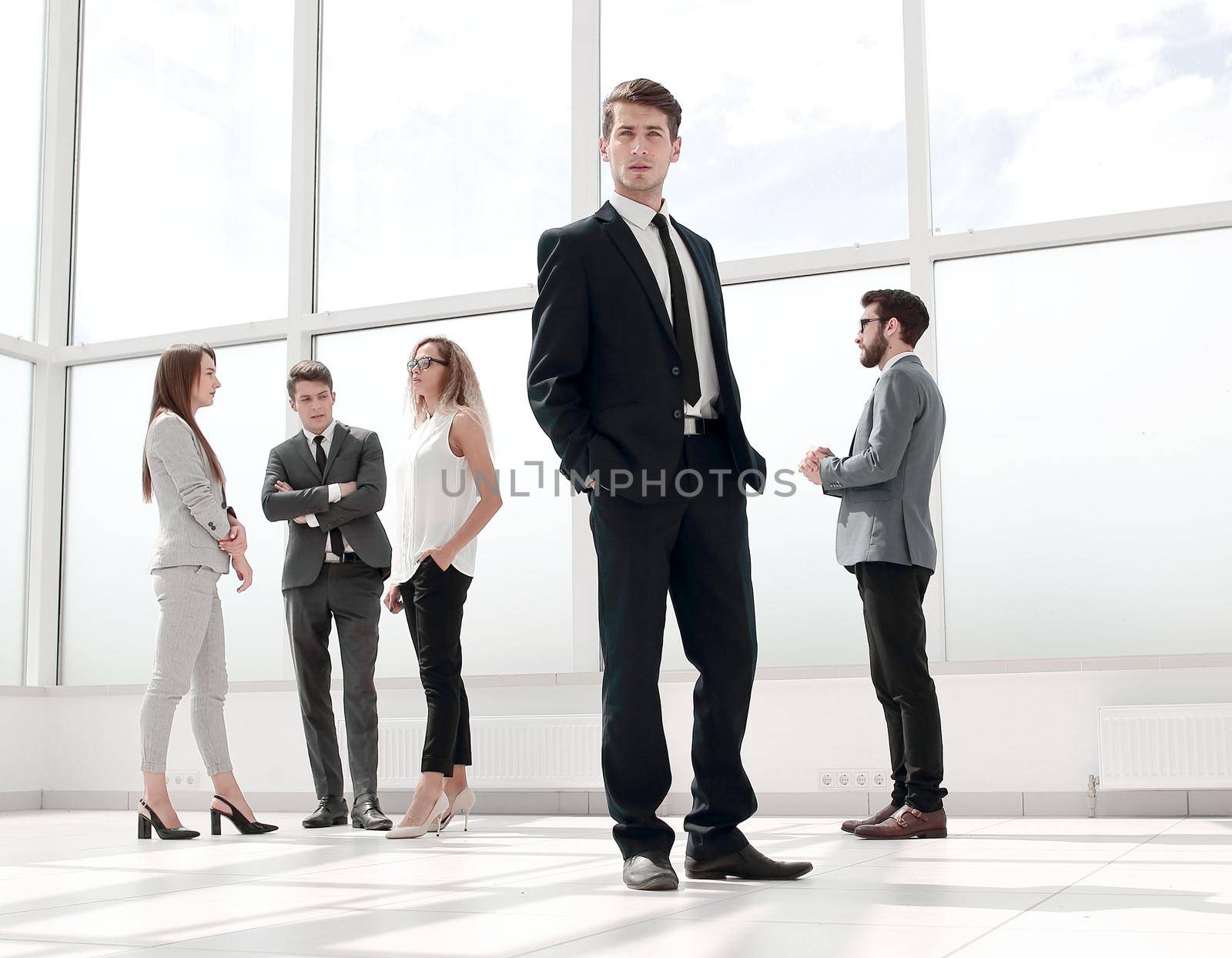 bottom view.confident businessman standing in a spacious hall .business and education