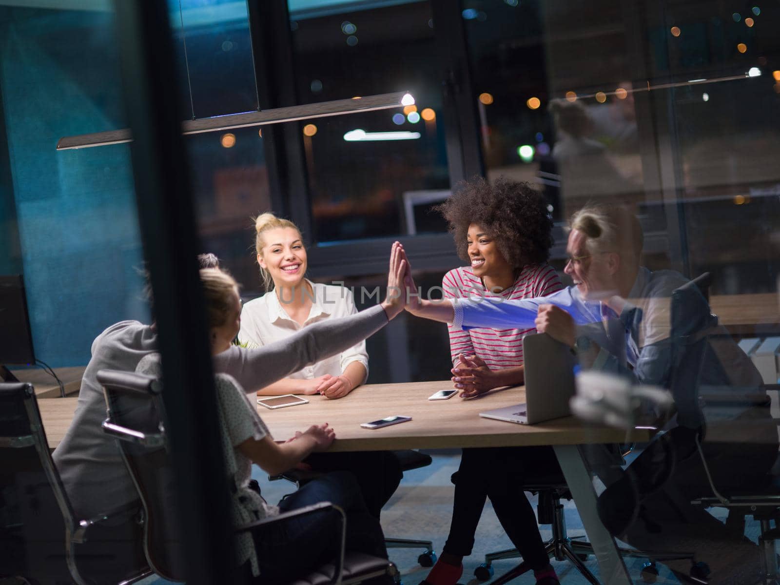 Multiethnic startup business team in night office by dotshock