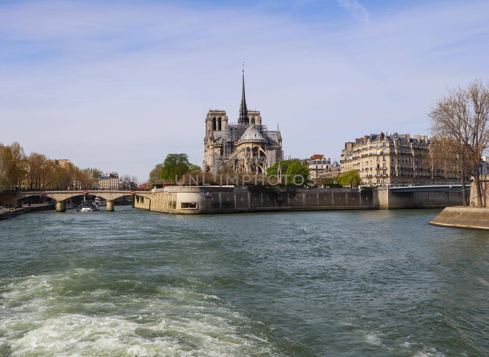 Paris / France - April 05 2019. Notre Dame Cathedral over Seine river in spring. Before the fire