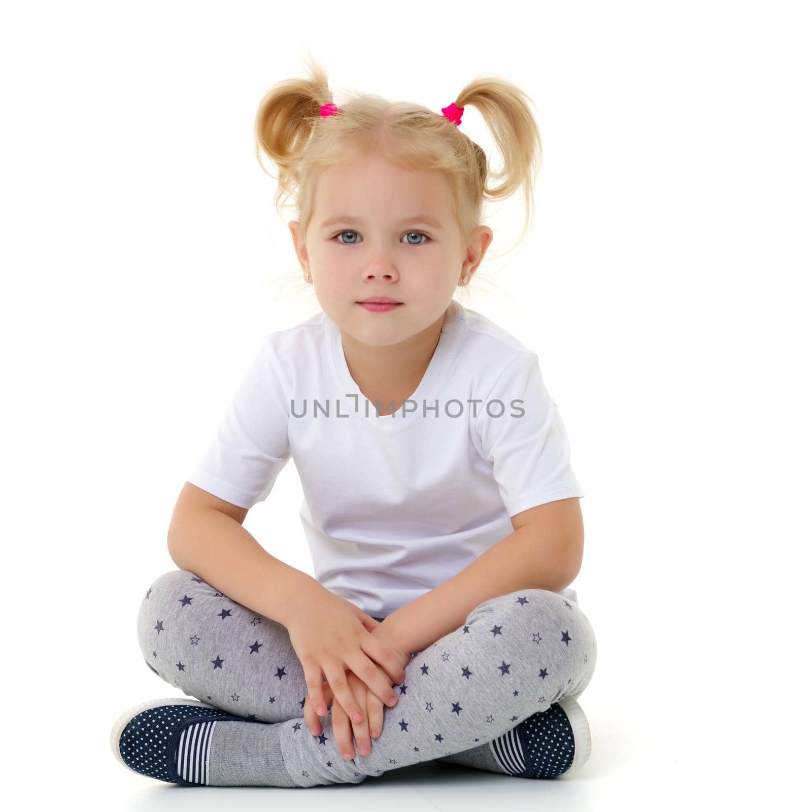 A little girl in a pure white T-shirt. by kolesnikov_studio