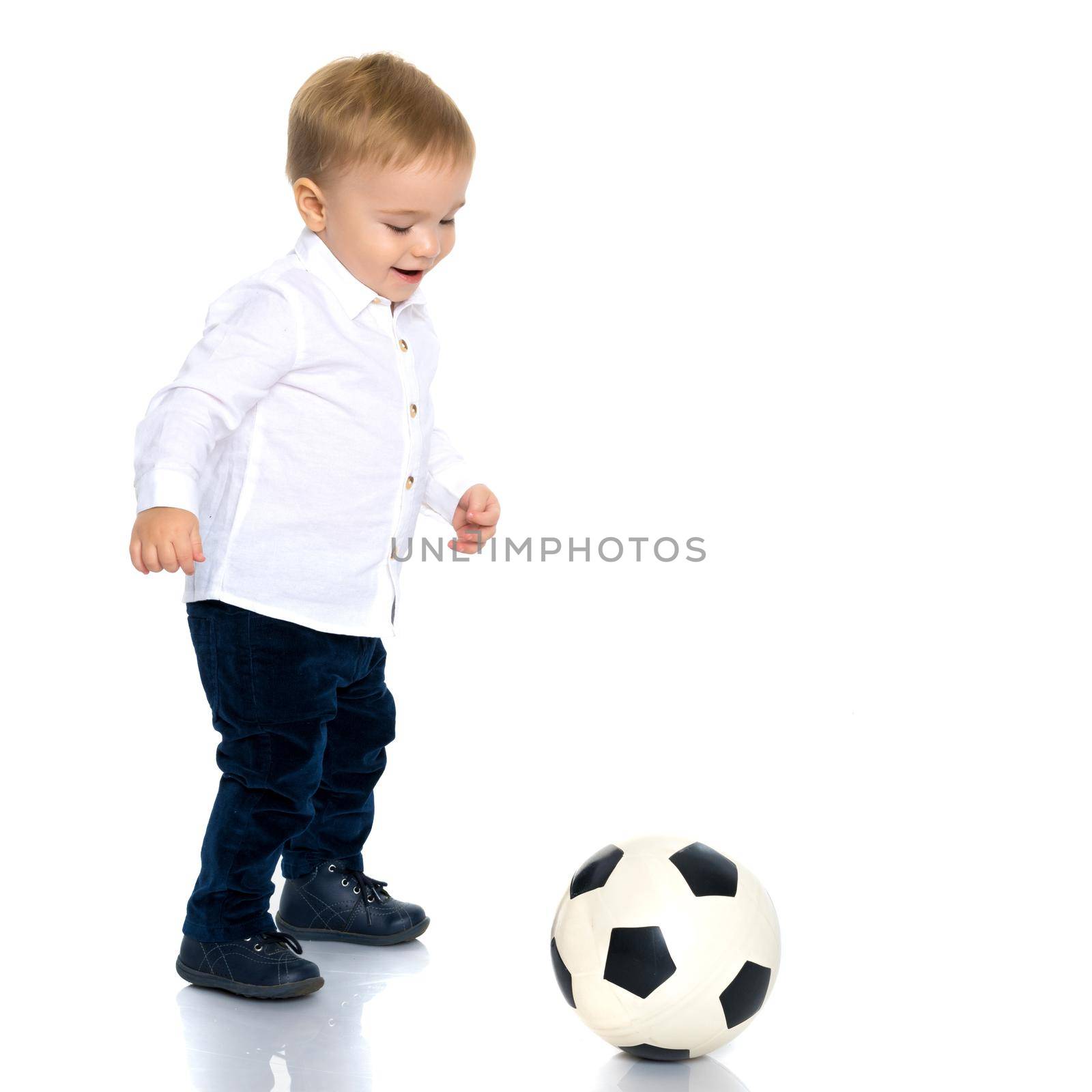 Little boy is playing with a soccer ball. by kolesnikov_studio
