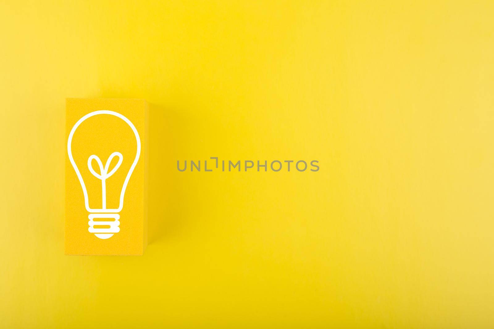 Concept of idea, creativity, start up or brainstorming. Light bulb drawn on yellow rectangle on yellow background with copy space