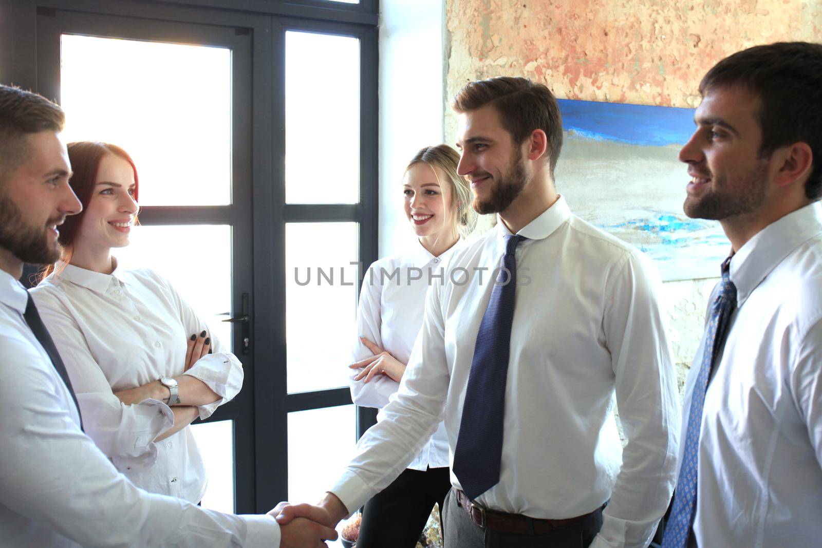 Business people shaking hands, finishing up a meeting. by tsyhun